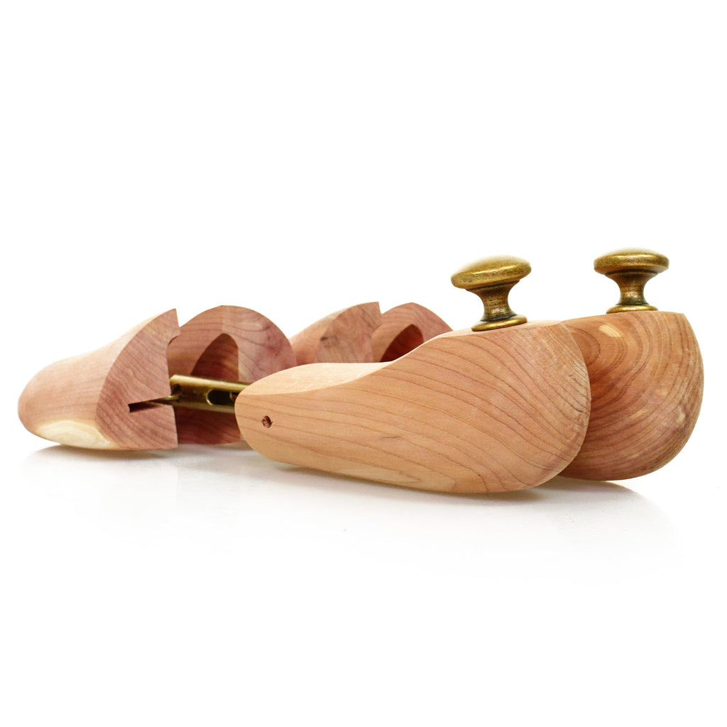 Two cedar wood shoe trees, showing their adjustable design from a side angle.