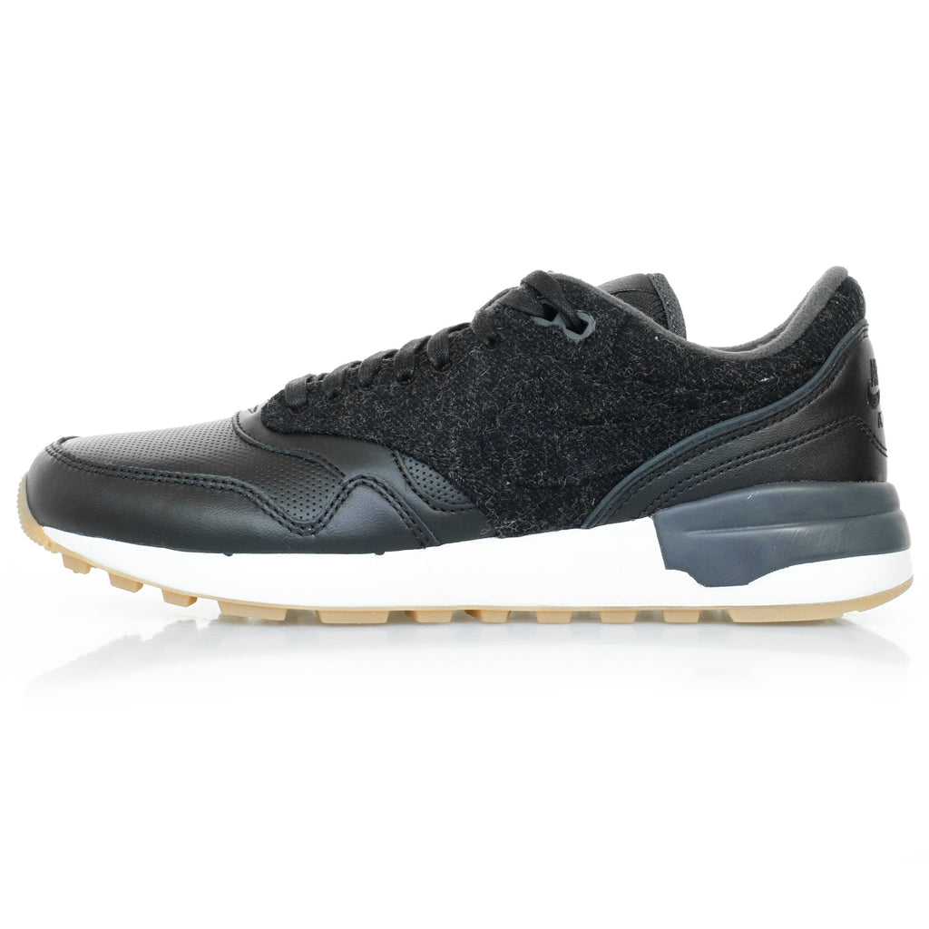 A single black trainer with a textured upper and white sole, viewed from the side.
