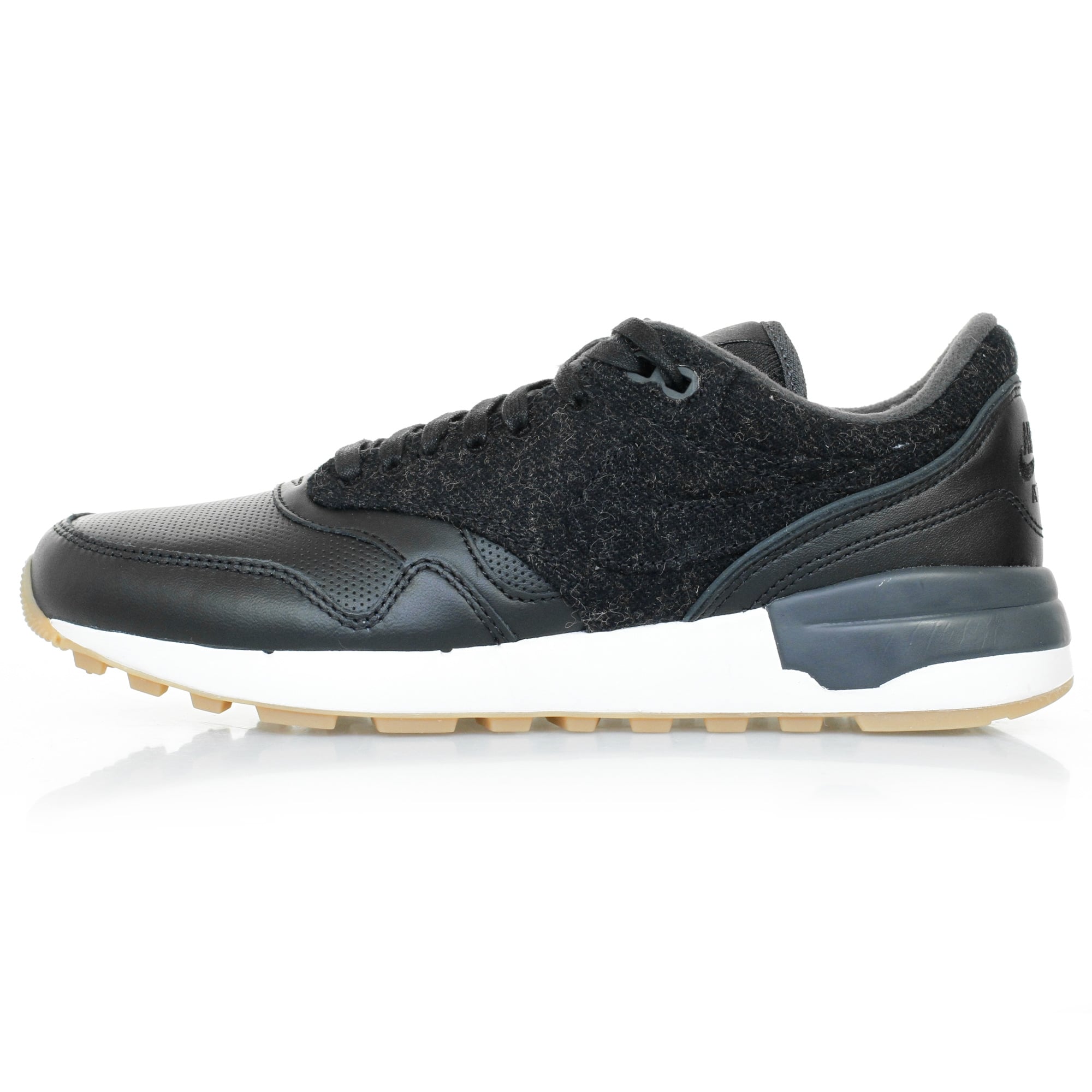 A single black trainer with a textured upper and white sole, viewed from the side.