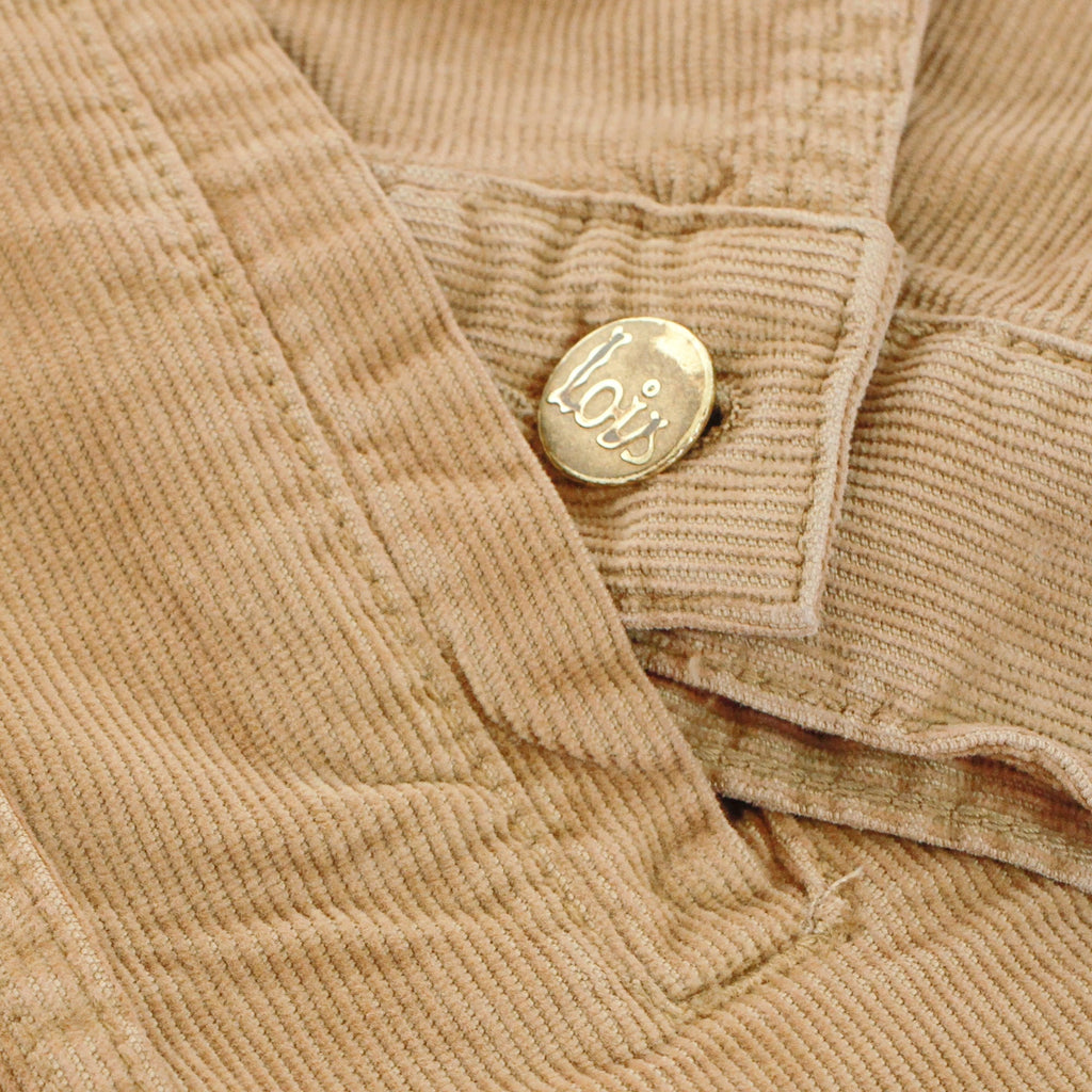 Close-up of a Lois-branded button on the cuff of the corduroy jacket.