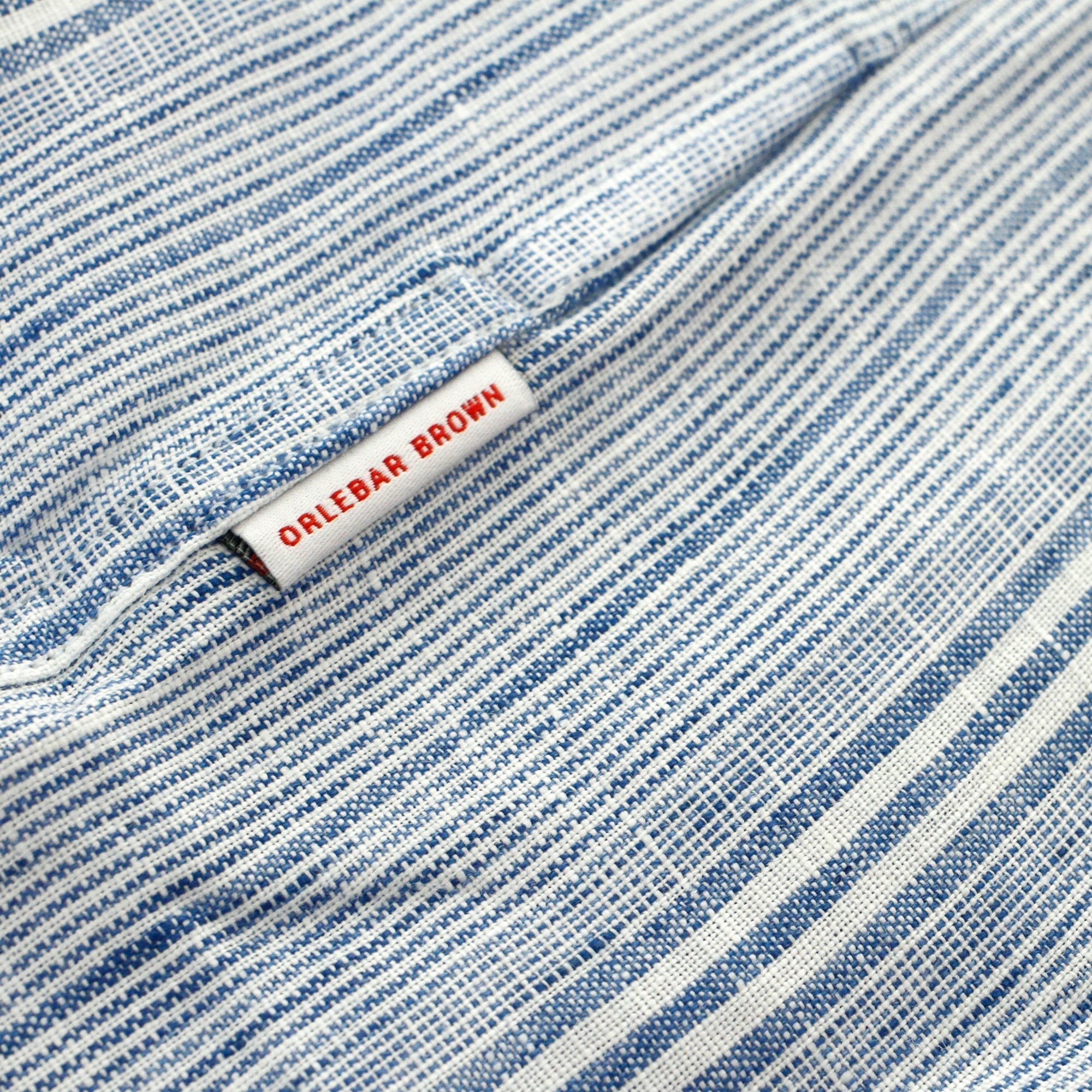 Close-up of the light blue and white striped fabric with an 'ORLEBAR BROWN' label.