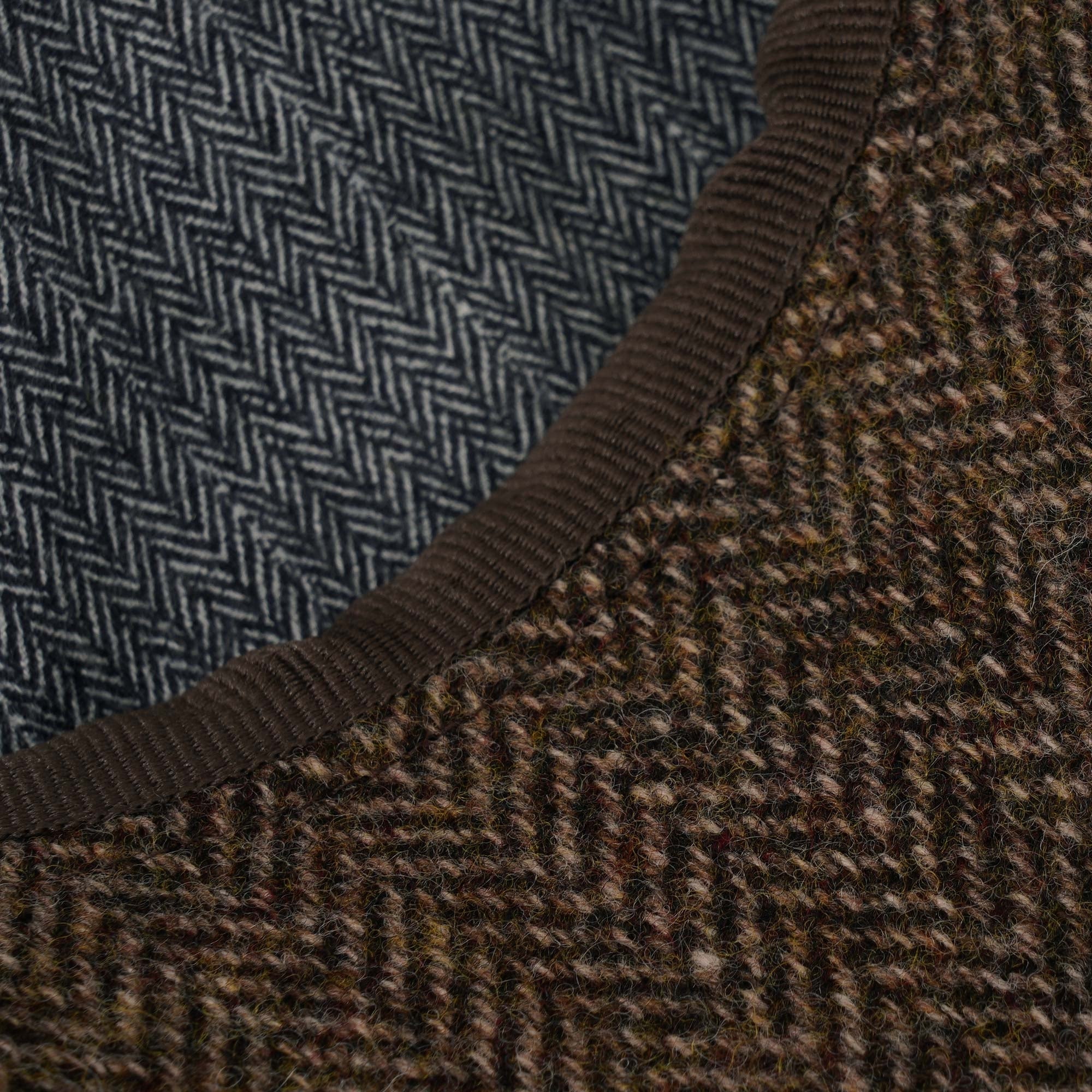 Close-up of the contrasting blue and brown herringbone patterns of the cap.