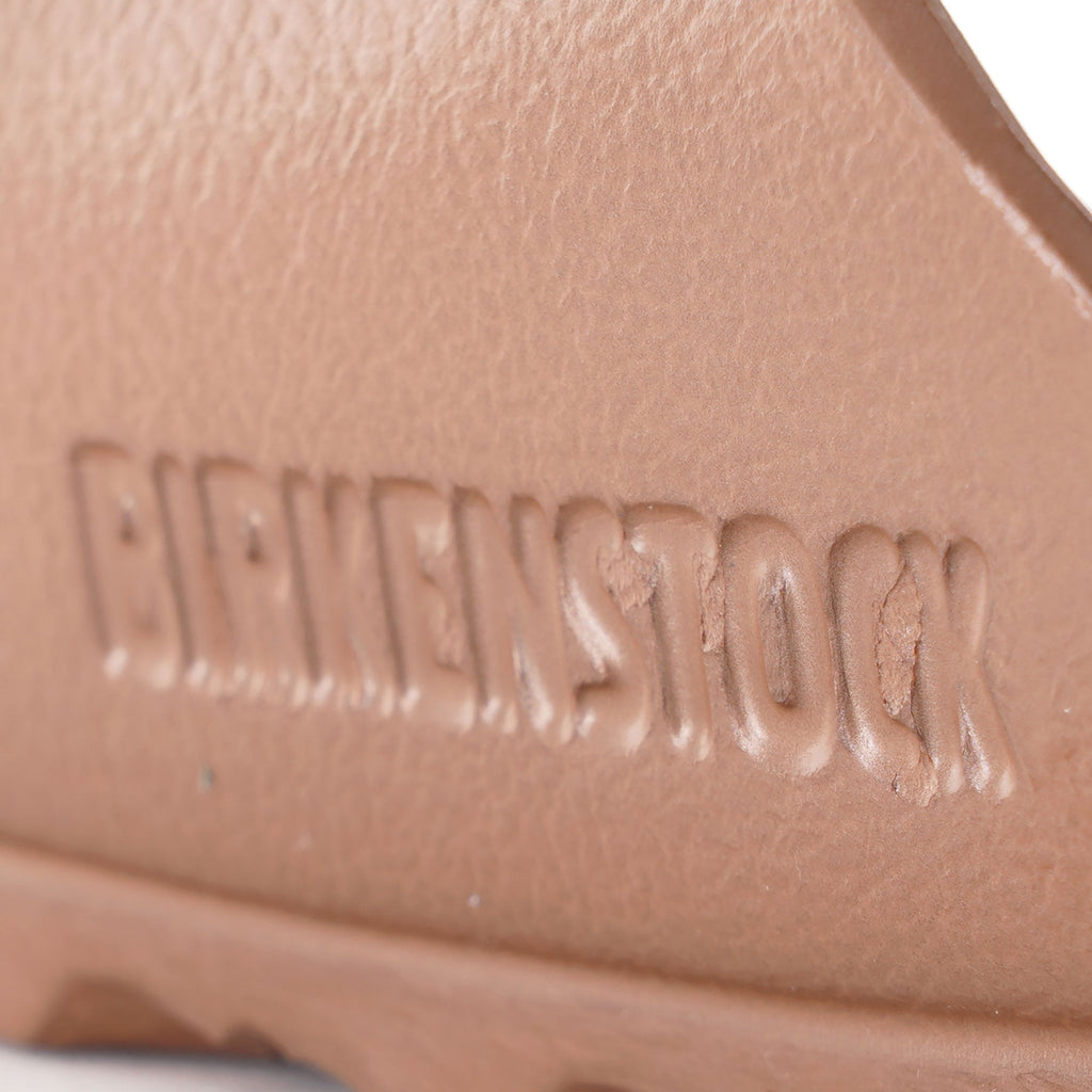 Close-up of the embossed Birkenstock logo on the footbed of the sandal.