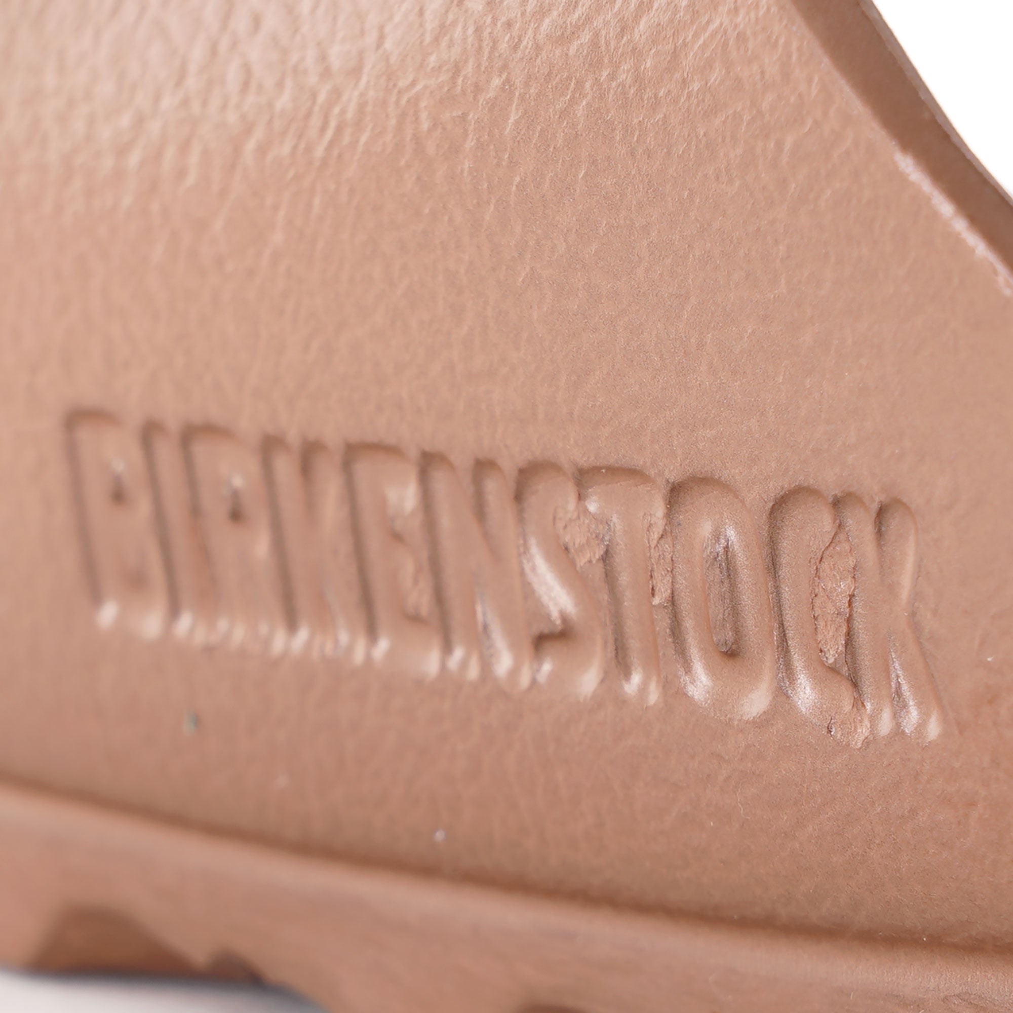 Close-up of the embossed Birkenstock logo on the footbed of the sandal.