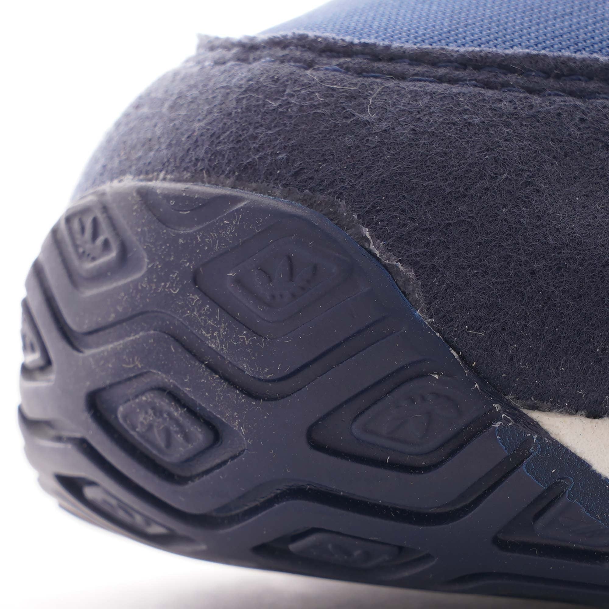A detailed shot of the rear sole of an Adidas TRX Soulround shoe, showing its texture.