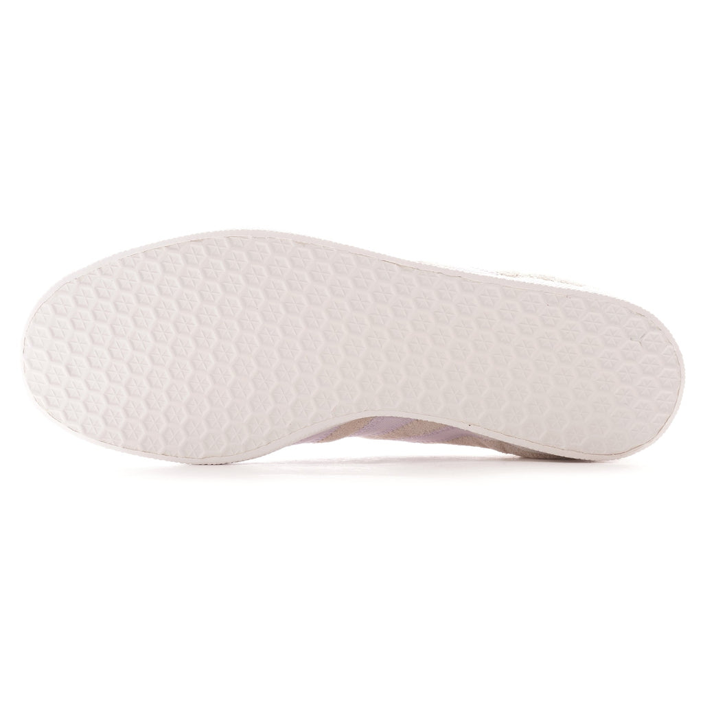 The textured white sole of a pale beige Adidas Gazelle trainer.