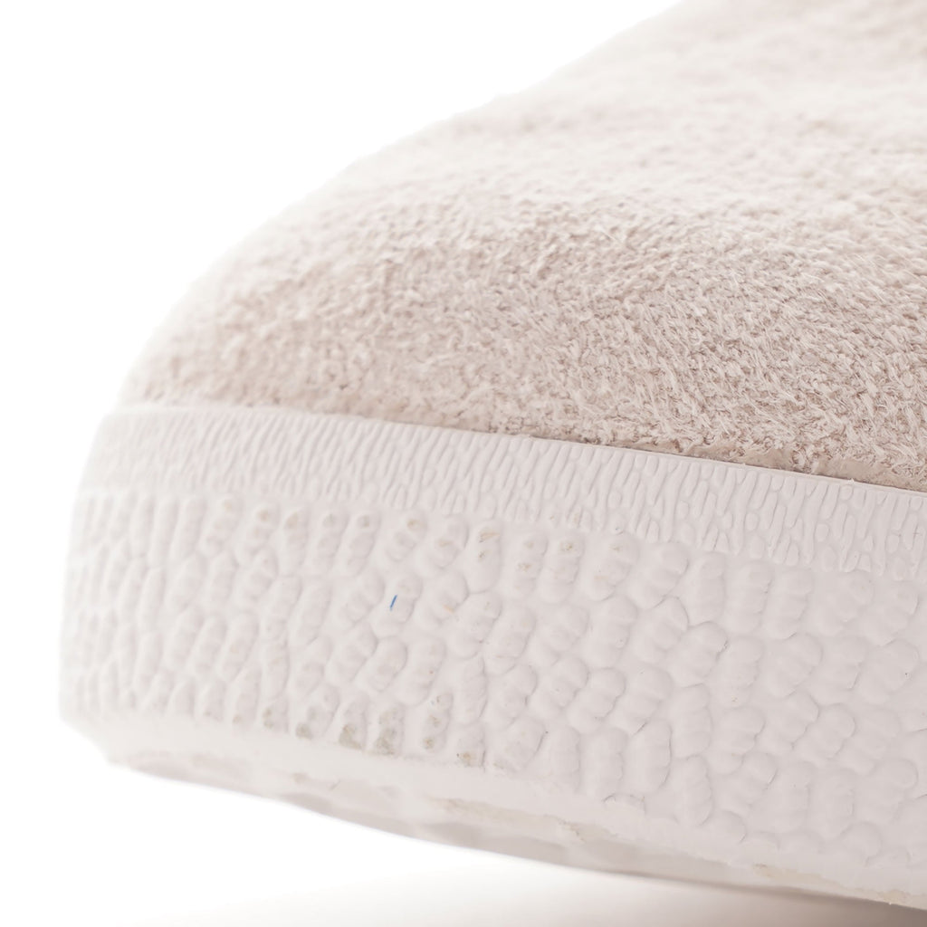 Close-up of the toe of a pale beige Adidas Gazelle trainer.
