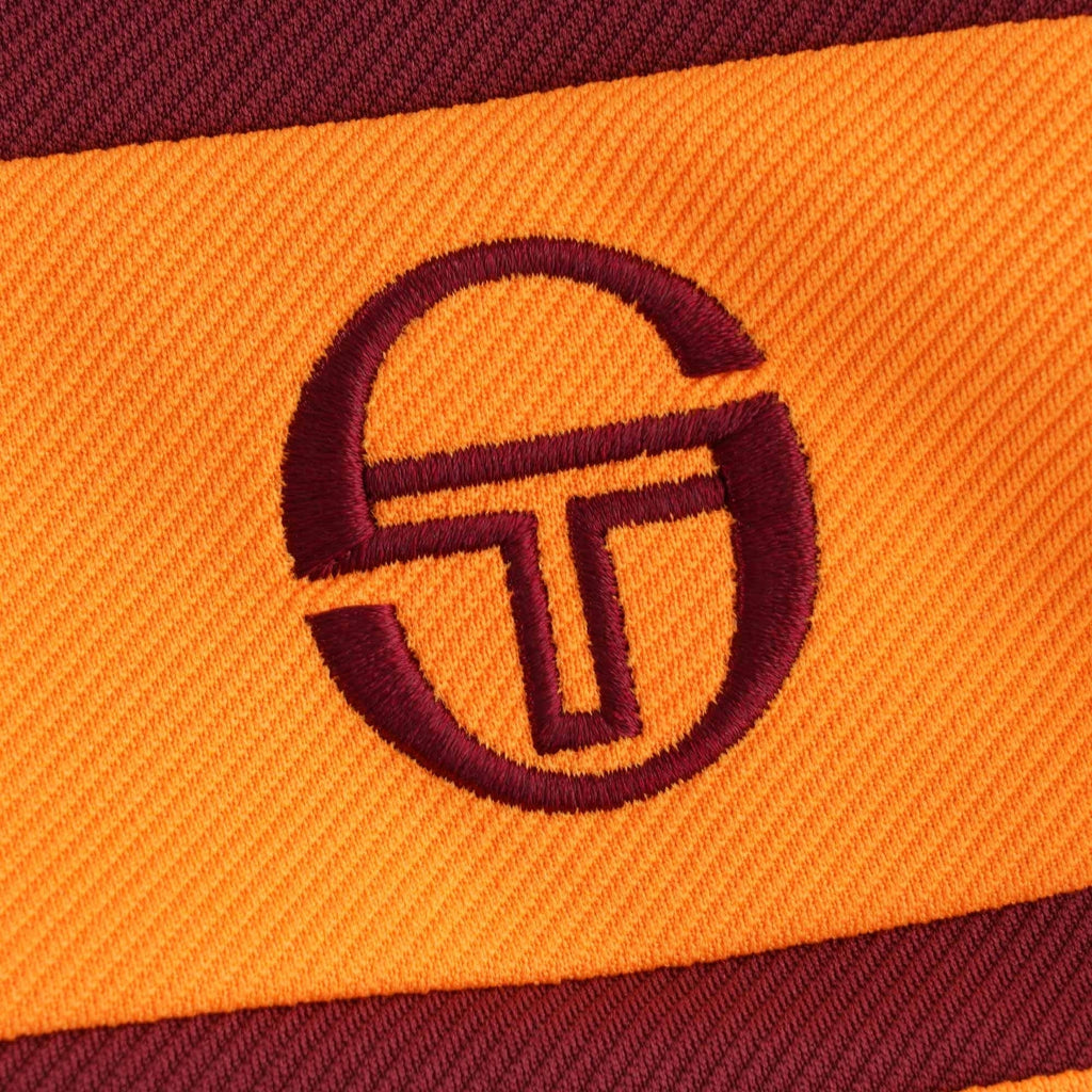 A close-up of the embroidered Sergio Tacchini logo on the track top.