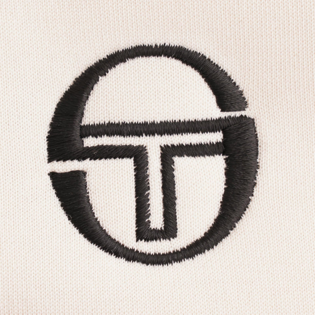 A close-up of the embroidered Sergio Tacchini logo on the chest.