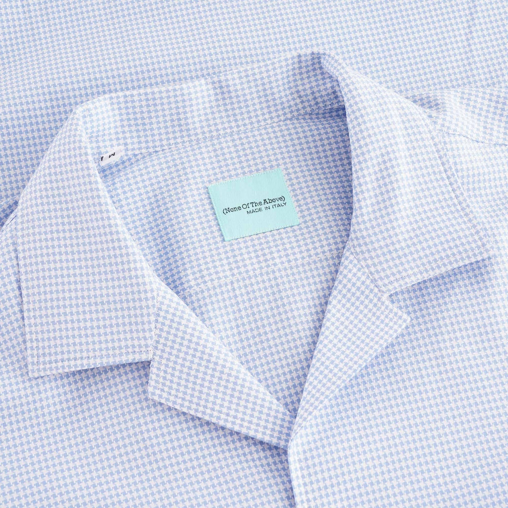 Close-up of the light blue houndstooth shirt's revere collar and neck label.