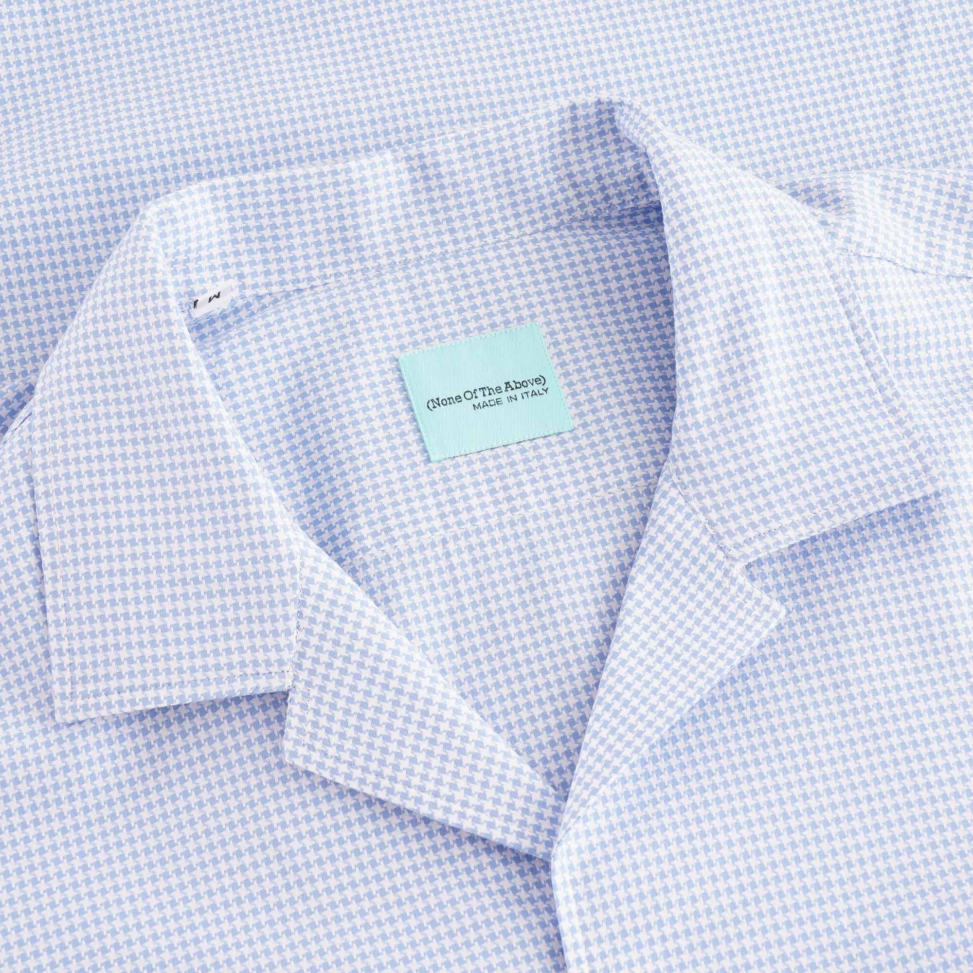Close-up of the light blue houndstooth shirt's revere collar and neck label.