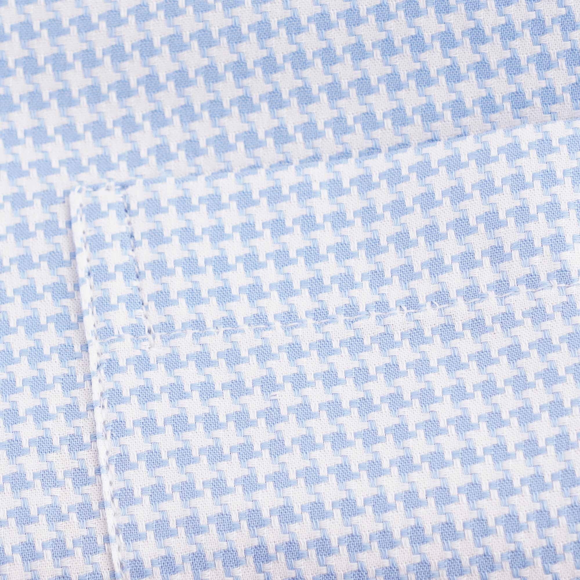 Detailed view of the light blue and white houndstooth fabric pattern on the shirt.