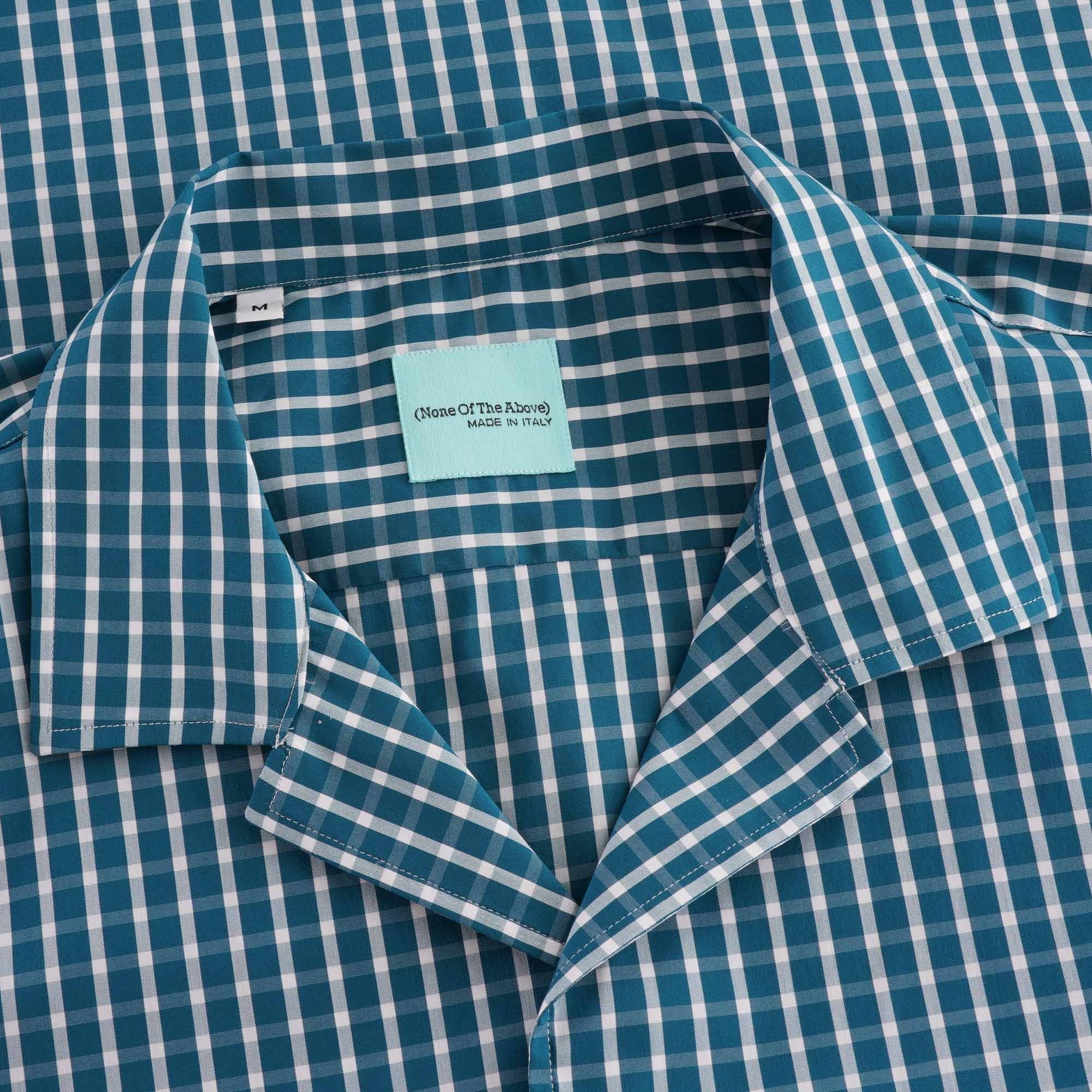 Close-up of the shirt collar, showing the checked pattern and brand label.