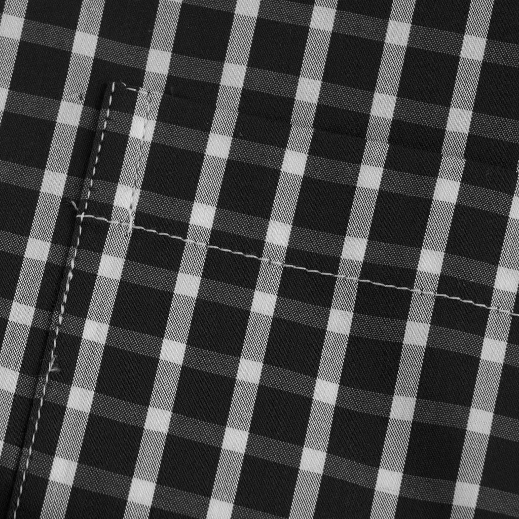 A close-up of the black and white checked fabric with visible stitching.