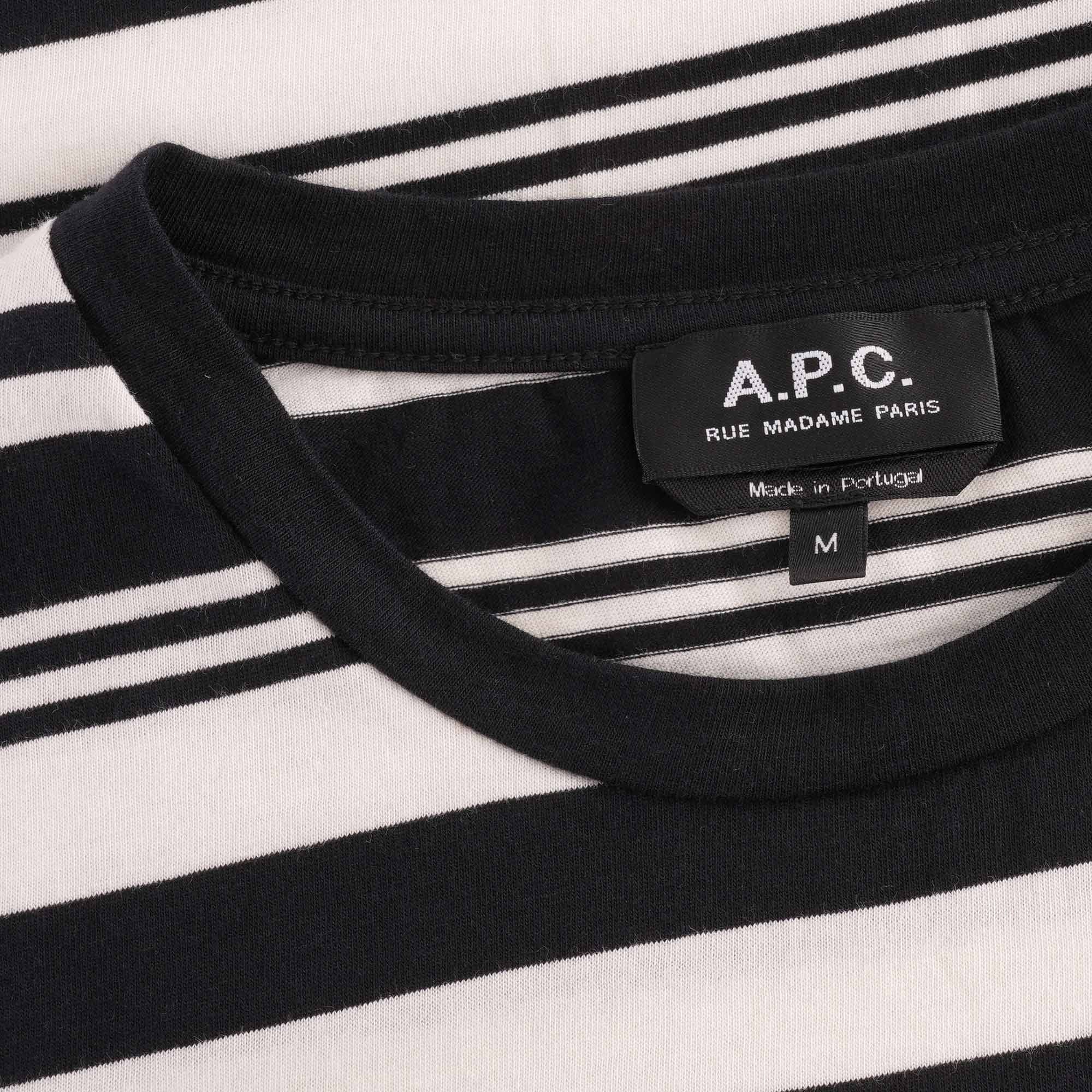 A close-up of the T-shirt's neckline and brand label, showing 'A.P.C.' and 'RUE MADAME PARIS'.