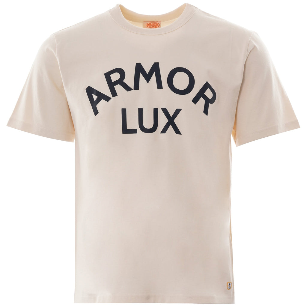 A close-up of a cream-coloured T-shirt with the words 'ARMOR LUX' in navy across the chest.