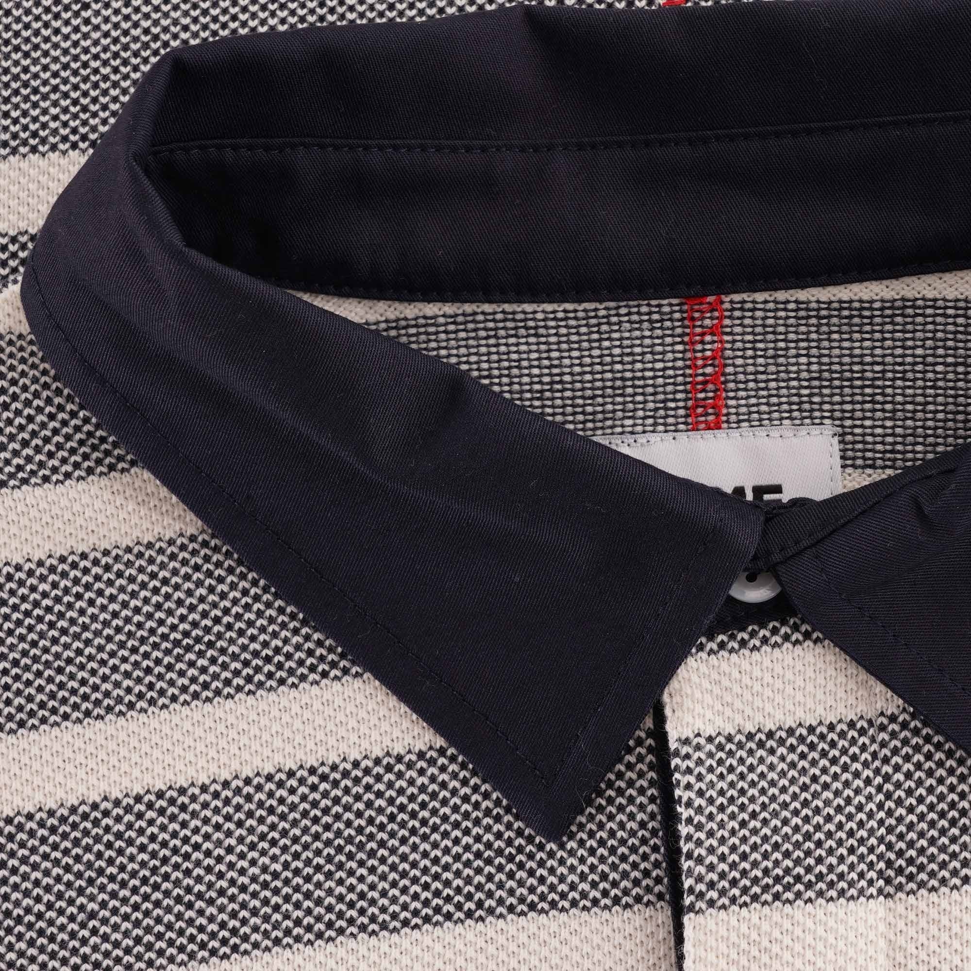 Close-up of the navy collar and upper chest of the striped long-sleeved polo shirt.