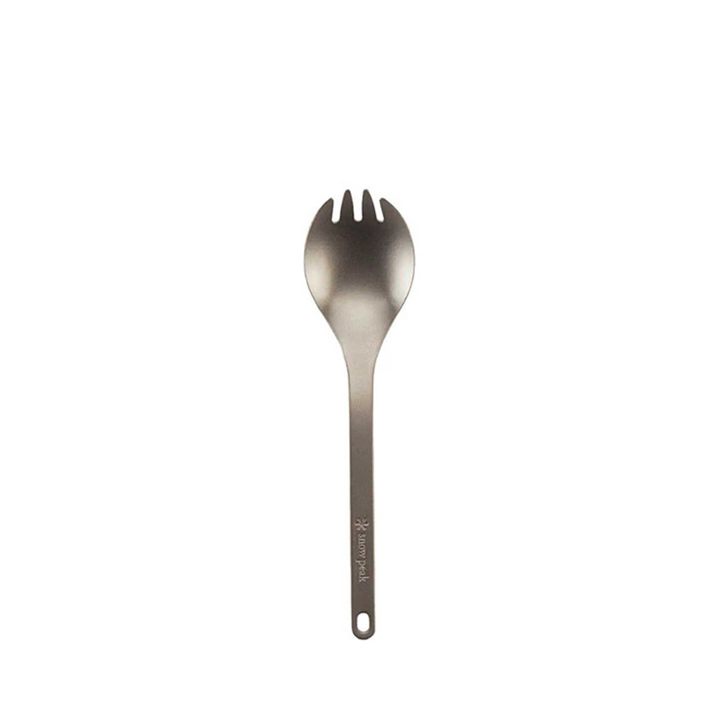 A close-up of a titanium spork on a white background, highlighting its versatile design.