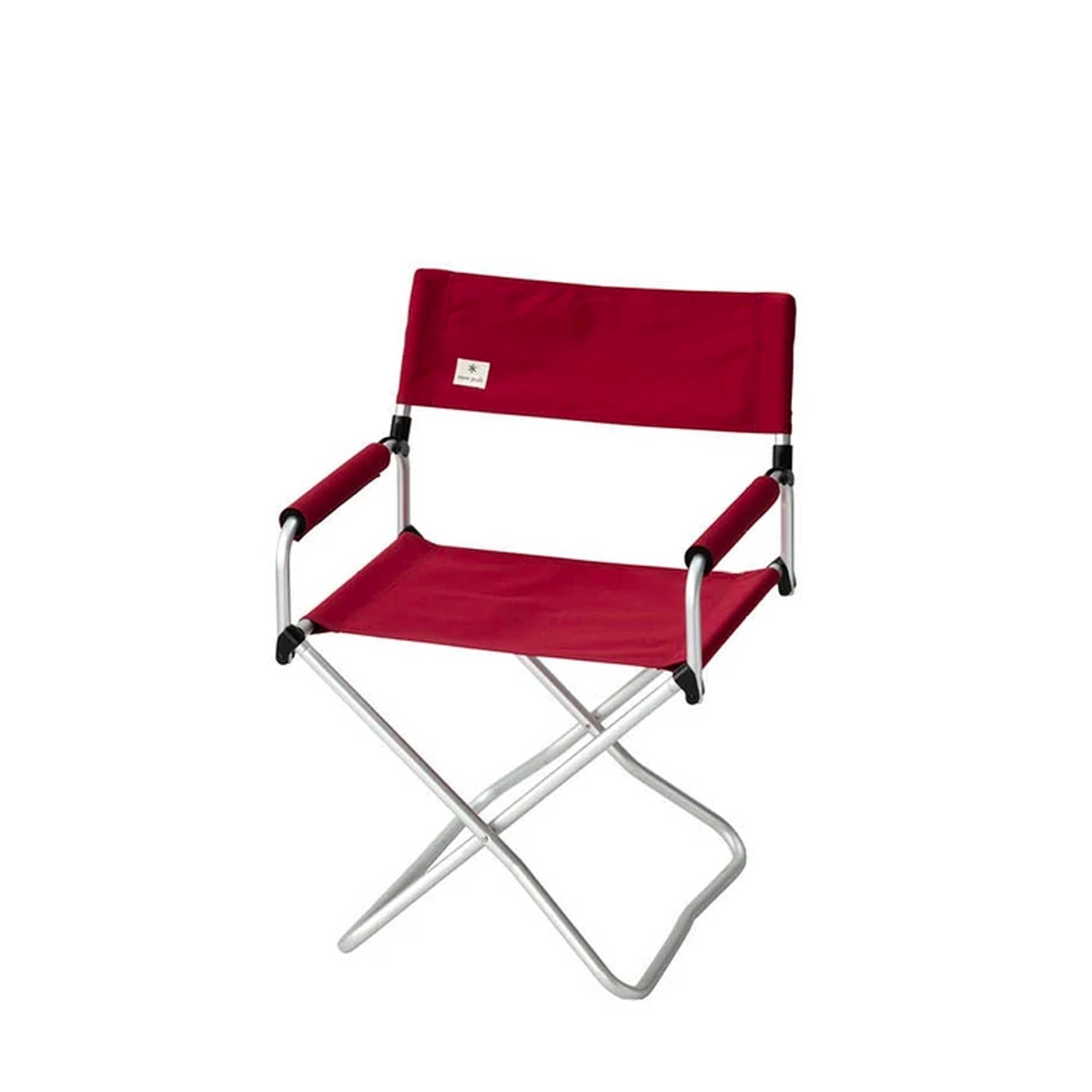 A red folding camping chair with a silver frame.