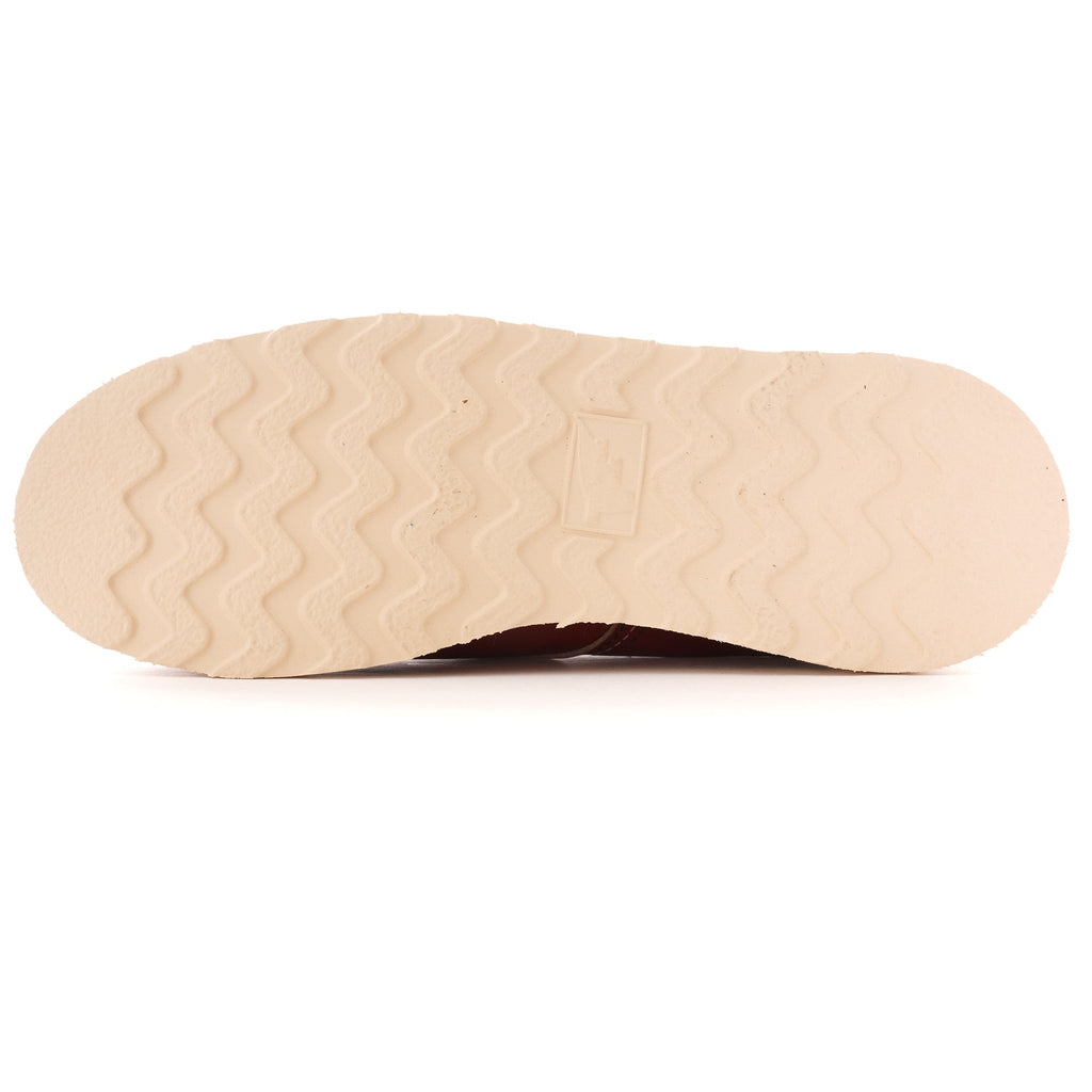 The textured, cream-coloured sole of a Red Wing Postman Oxford shoe in Oro Russet.