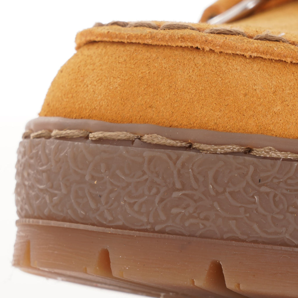Close-up of the textured trim around the sole of a mustard yellow Mephisto 'Rainbow' shoe.