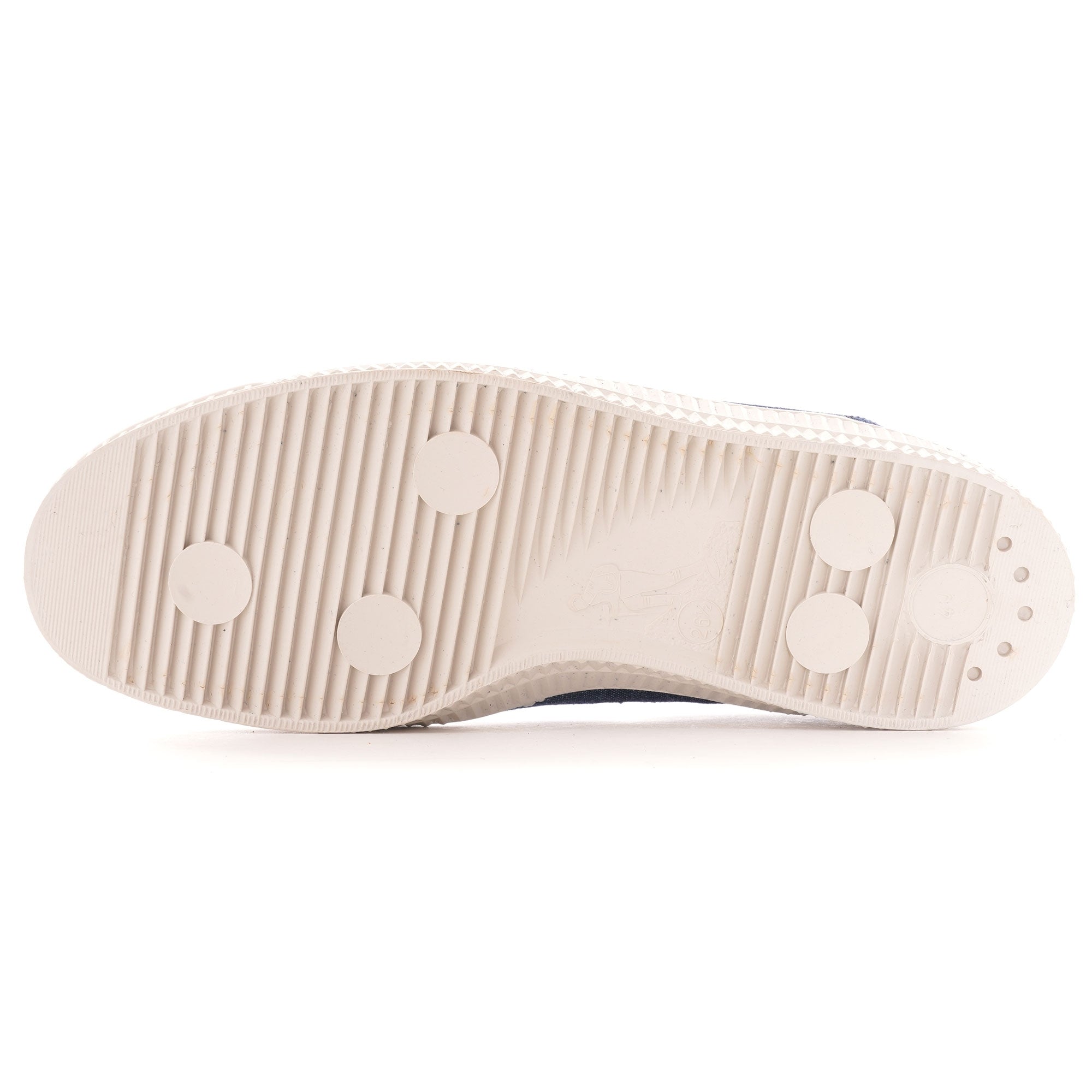 Bottom view of the shoe's sole, showing its textured grip and circular patterns.