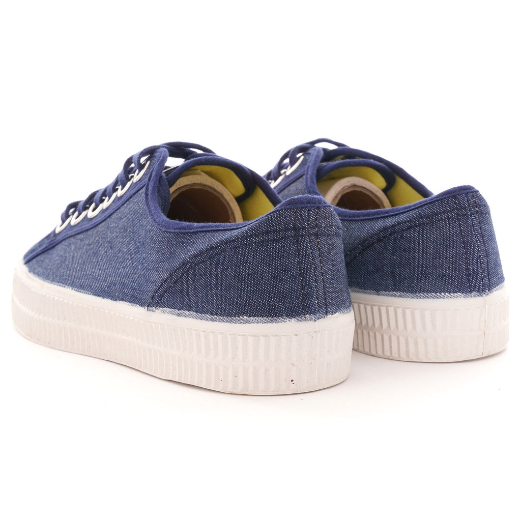 Rear view of the pair of shoes, highlighting the navy blue canvas and white soles.