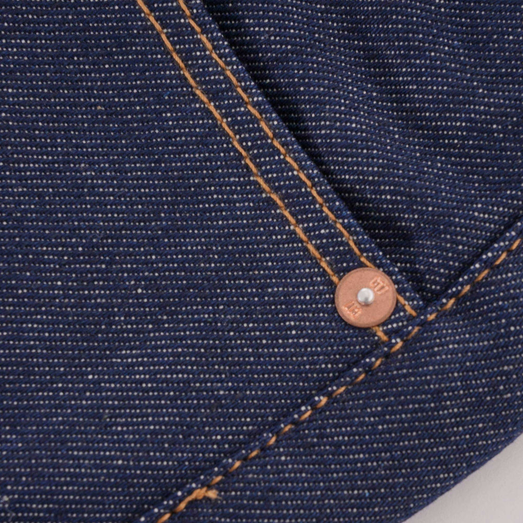 Close-up of a front pocket on C17 jeans, showing copper rivet and stitching.