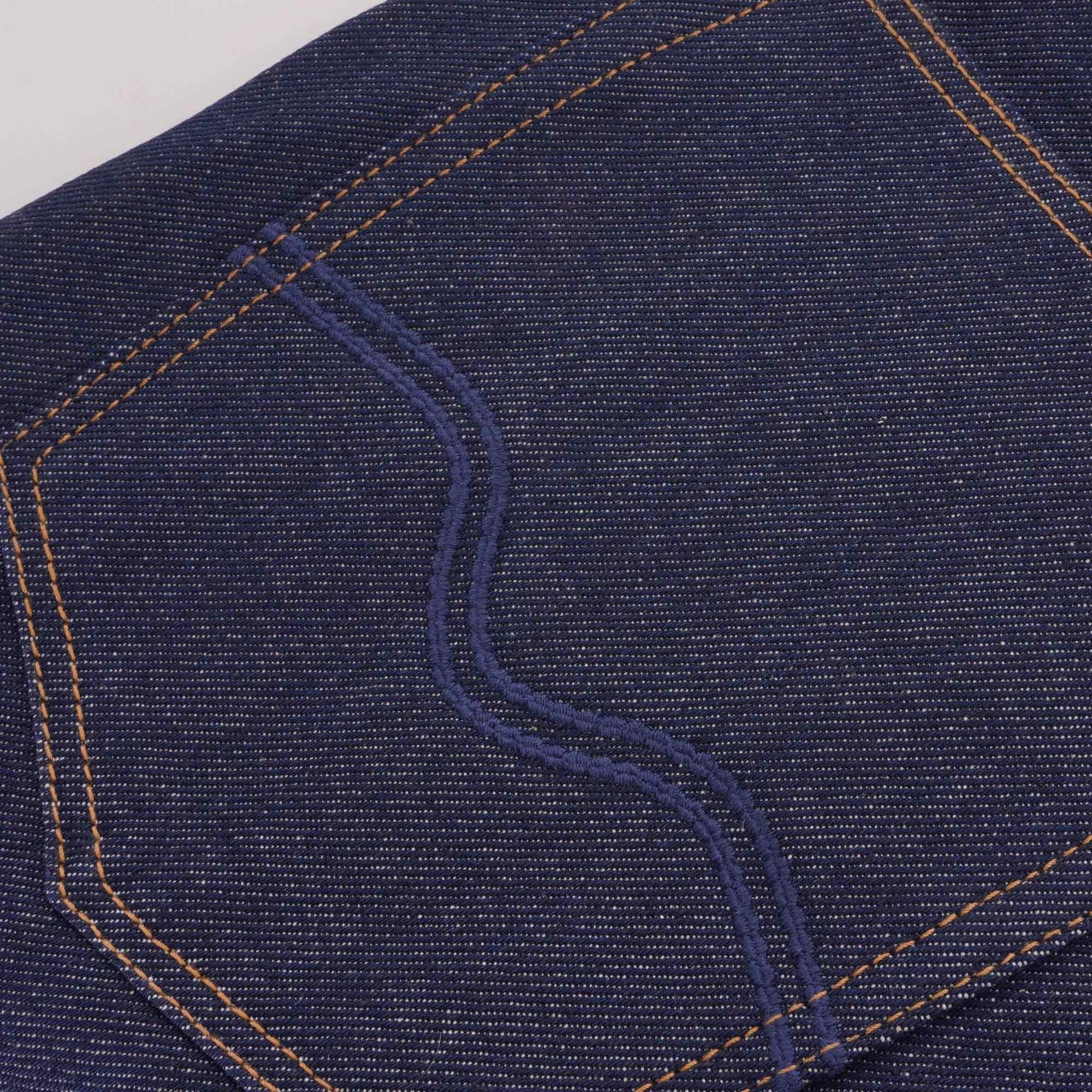 Close-up of a rear pocket on C17 jeans, showing decorative stitching.