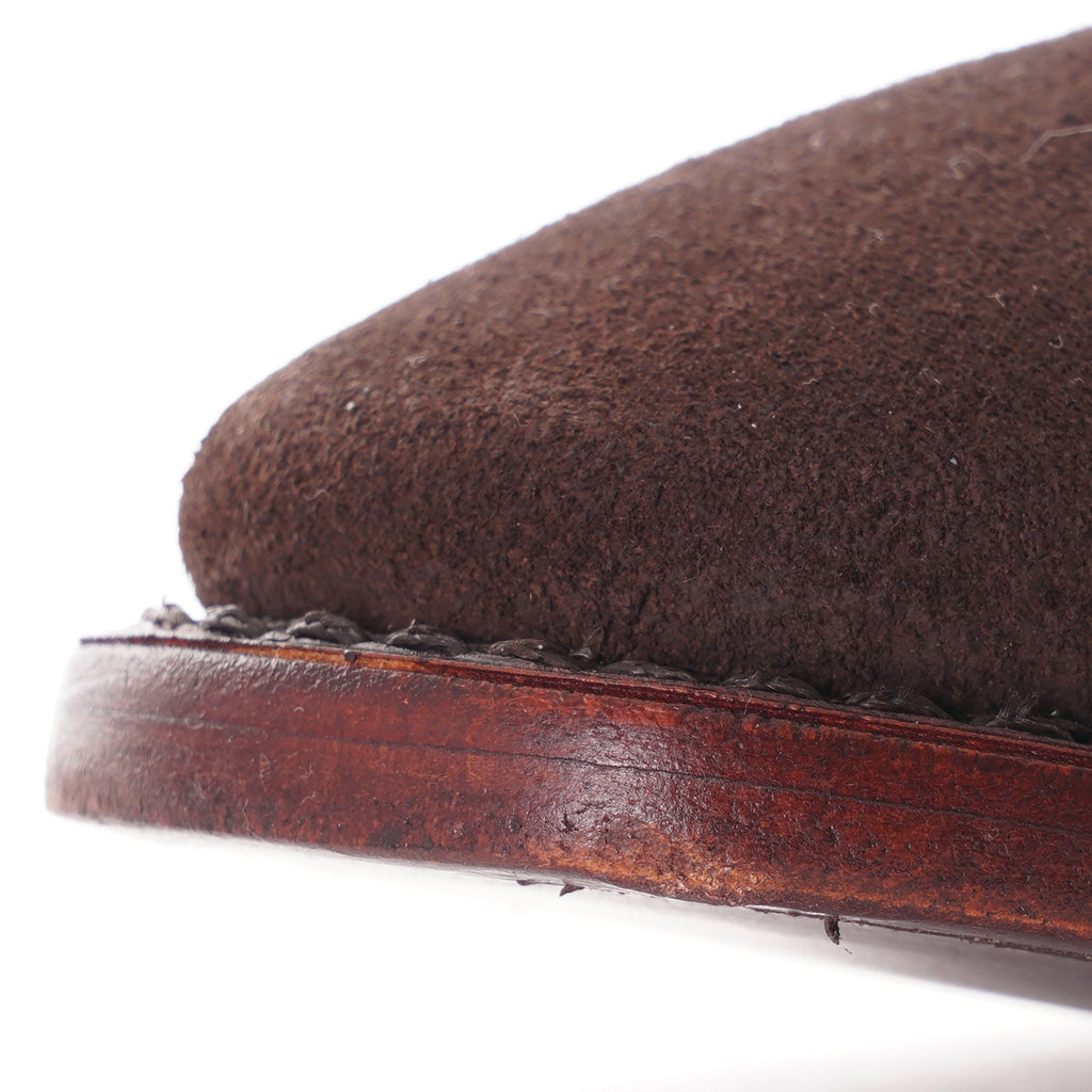 Close-up of the toe box and sole stitching of a brown suede Chelsea boot.