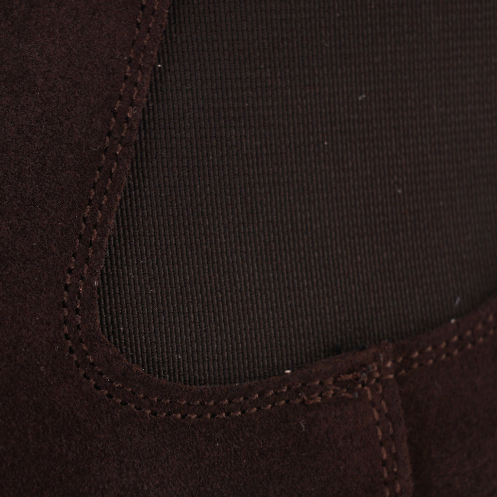 Close-up of the elasticated side panel on a brown suede Chelsea boot.