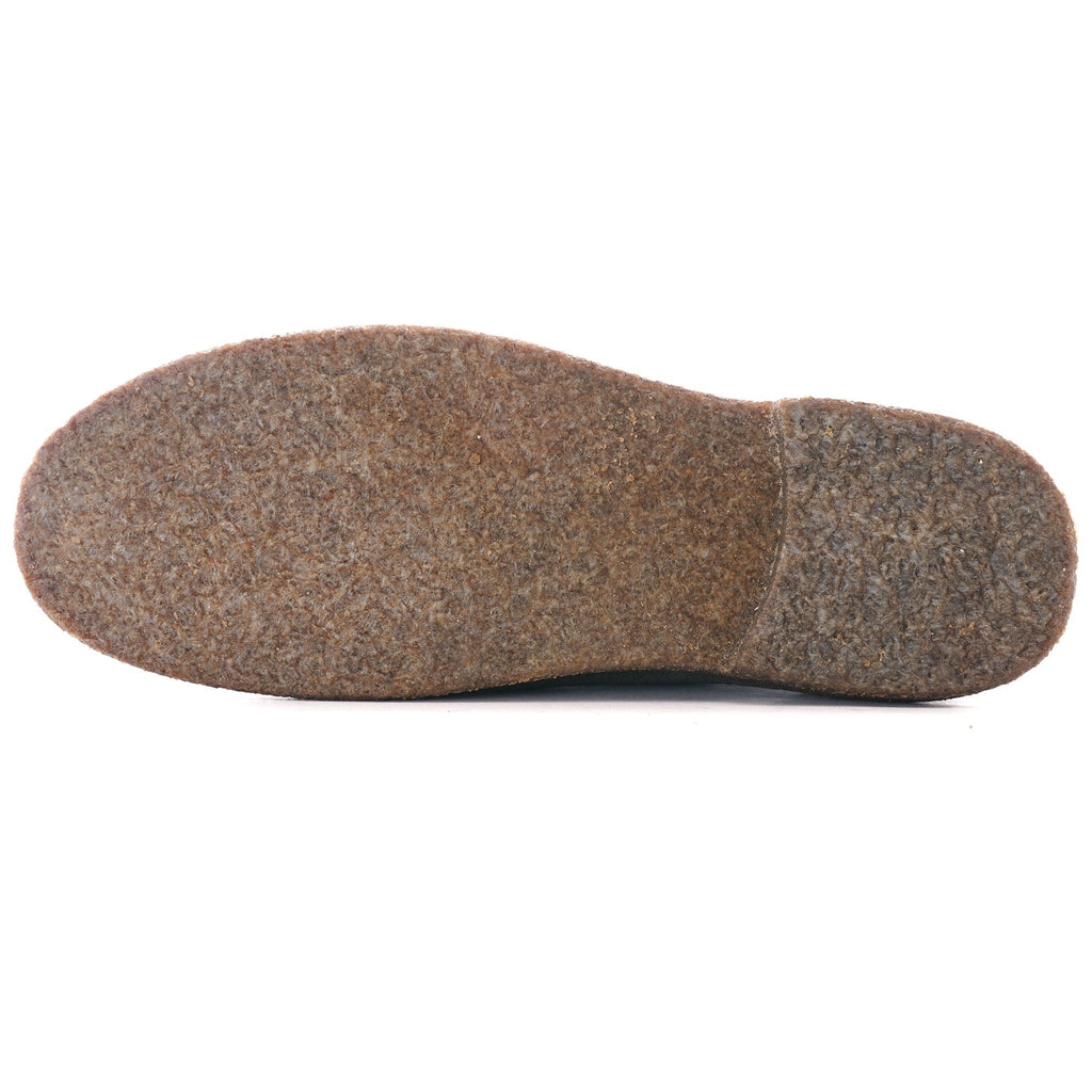 Bottom of a brown crepe sole from a grey suede desert boot.