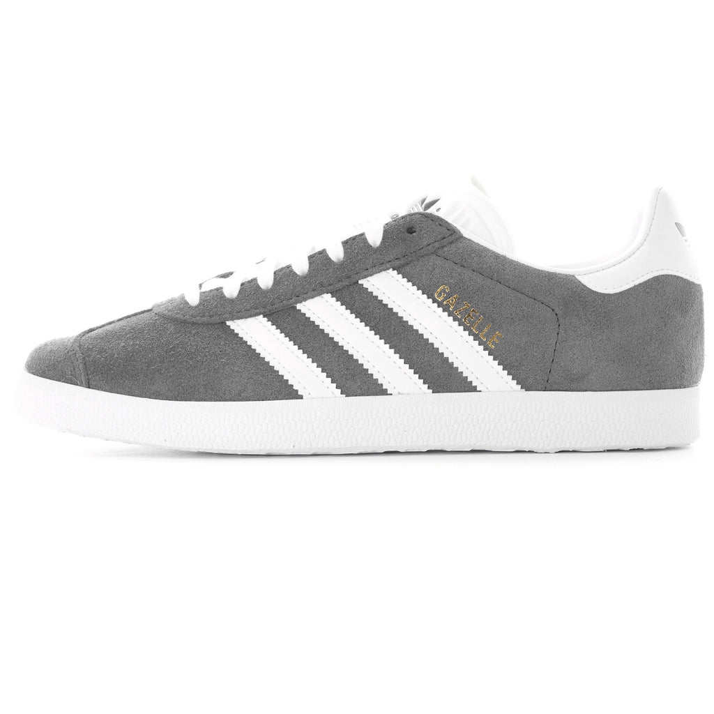 Side profile of a grey Adidas Gazelle trainer with white stripes and sole.