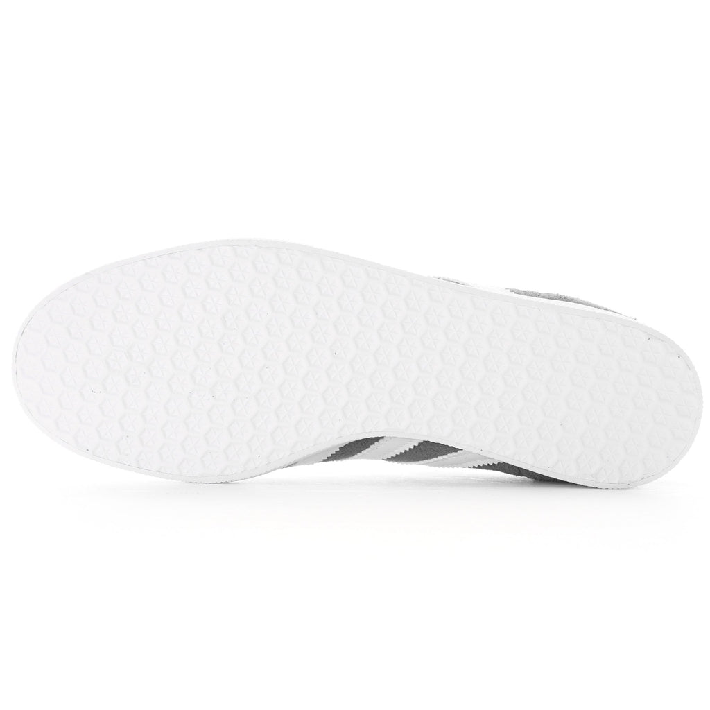 Bottom of a grey Adidas Gazelle trainer with a white textured sole.