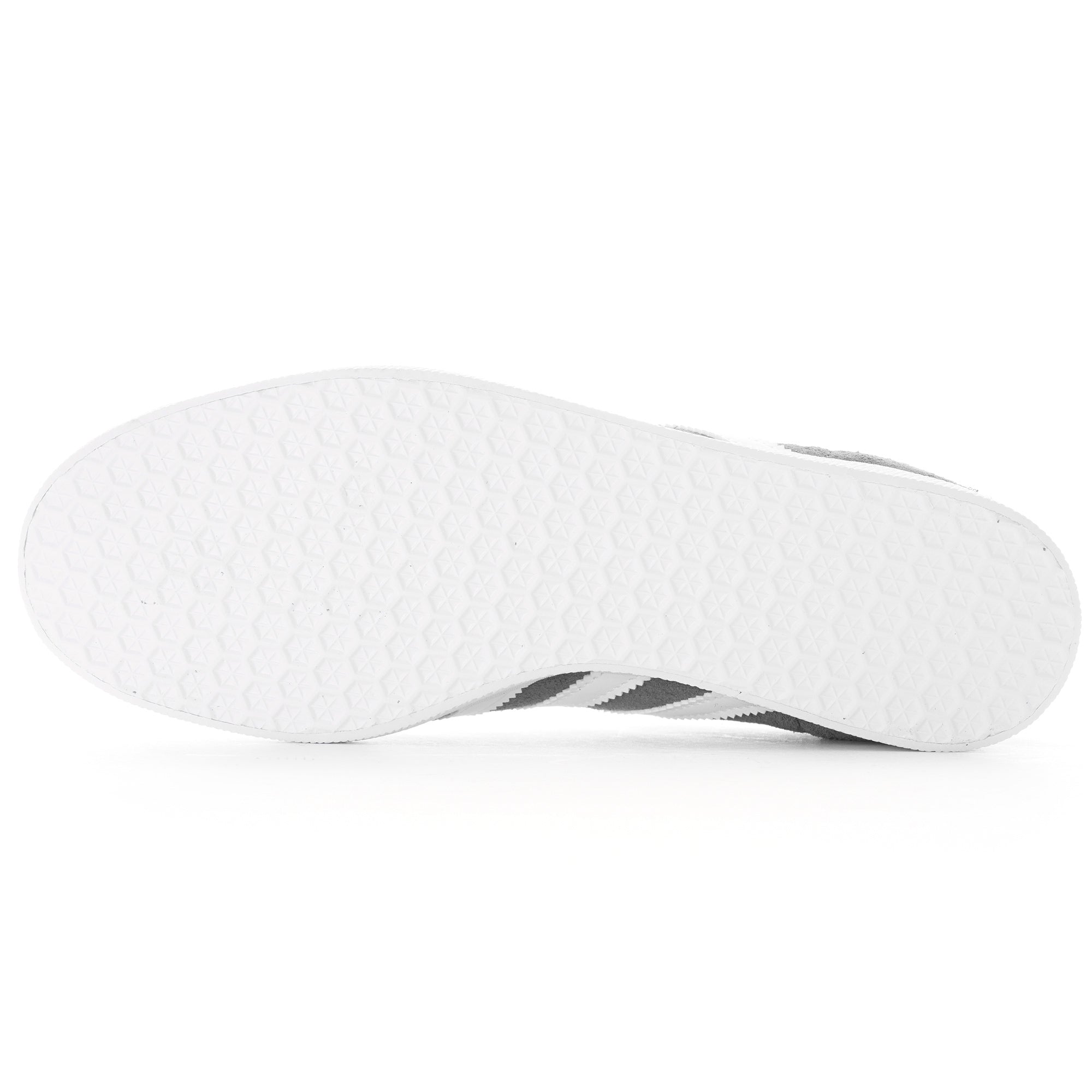 Bottom of a grey Adidas Gazelle trainer with a white textured sole.