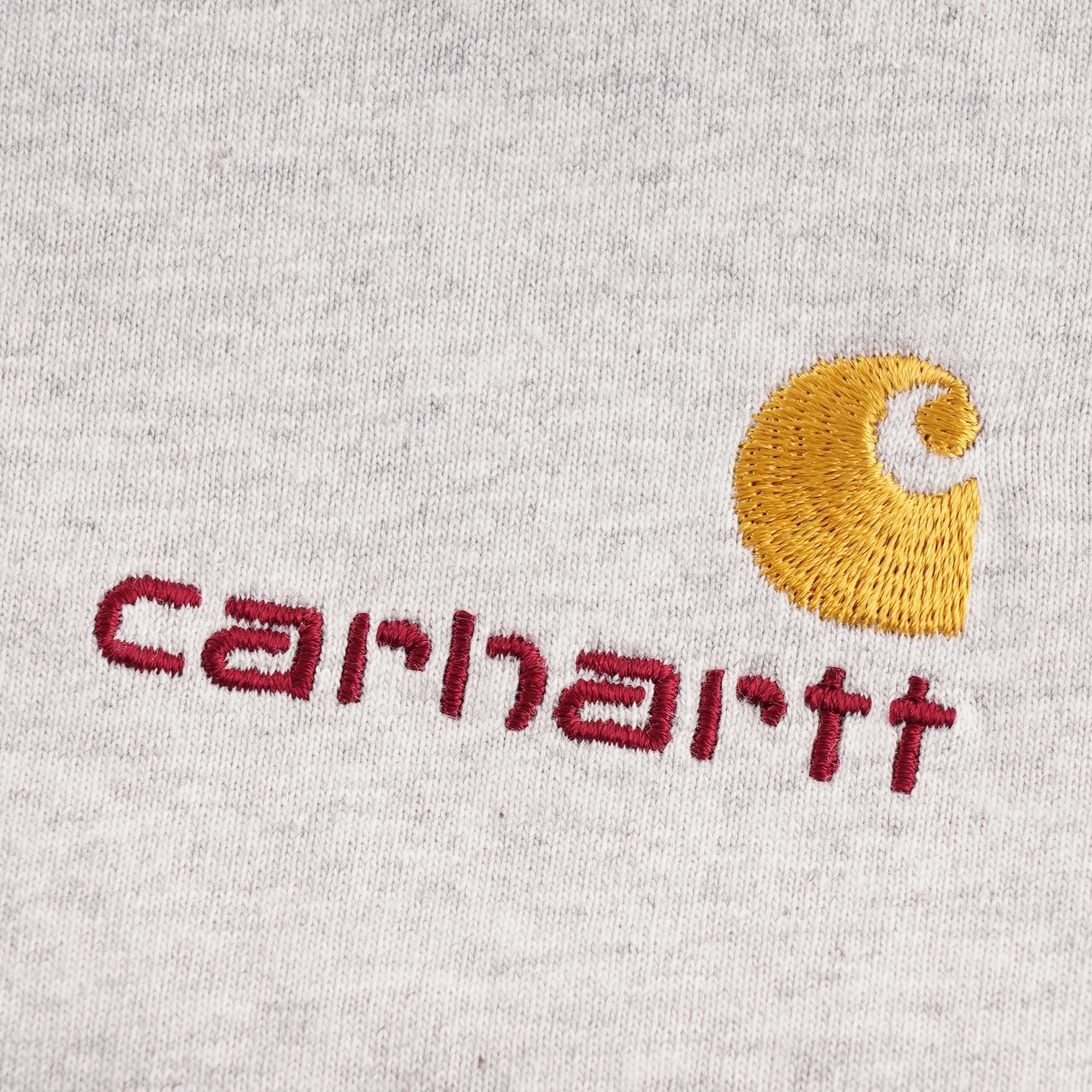 Close-up of the Carhartt WIP embroidered logo on the grey t-shirt.