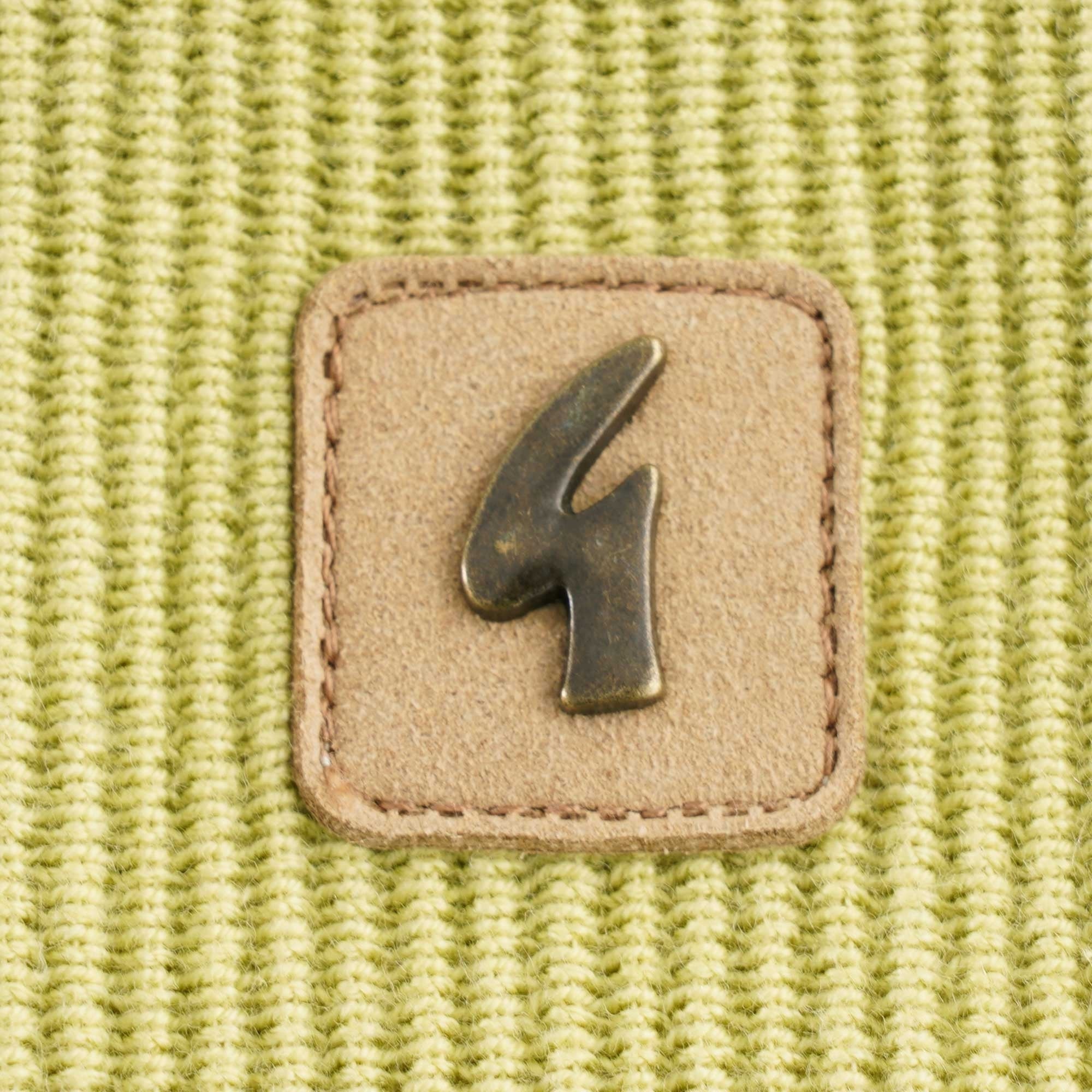 A detailed shot of the square brand patch with a metallic '4' logo.