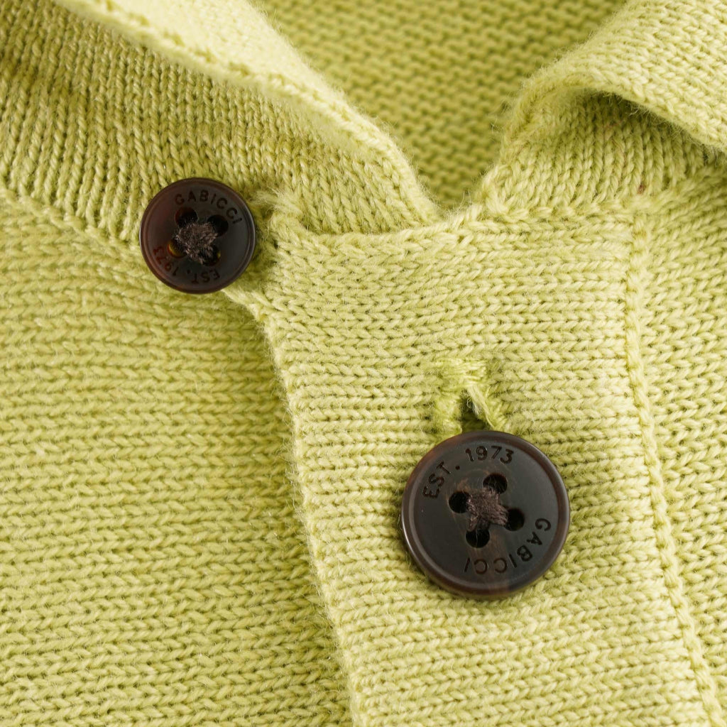 A close-up of the shirt's buttons, revealing brand lettering on them.