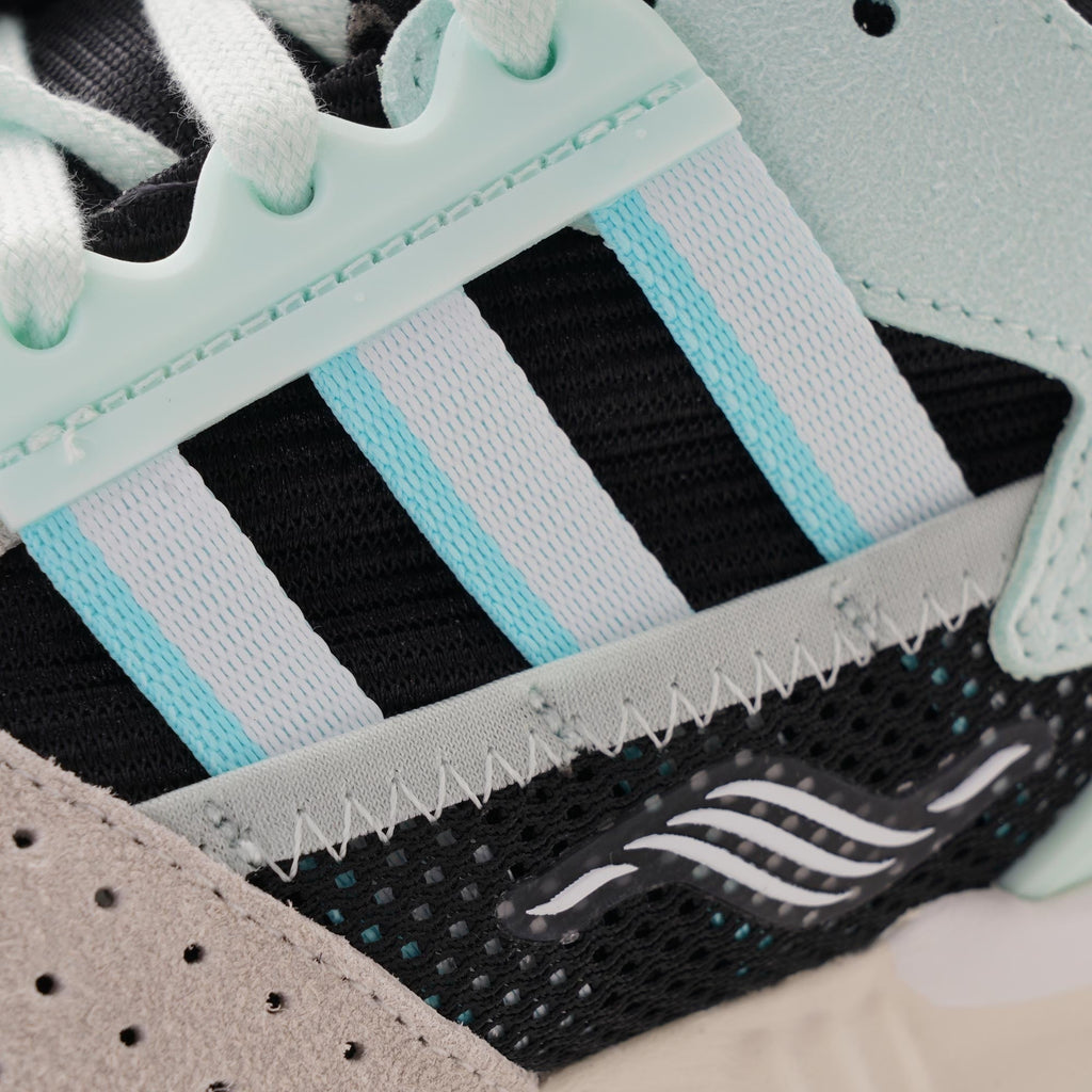 Close-up of the signature three stripes on an Adidas ZX 8000 Clear Aqua trainer.
