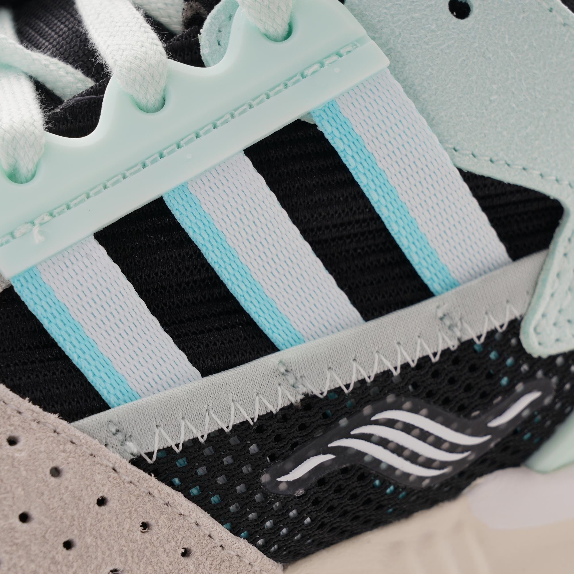 Close-up of the signature three stripes on an Adidas ZX 8000 Clear Aqua trainer.