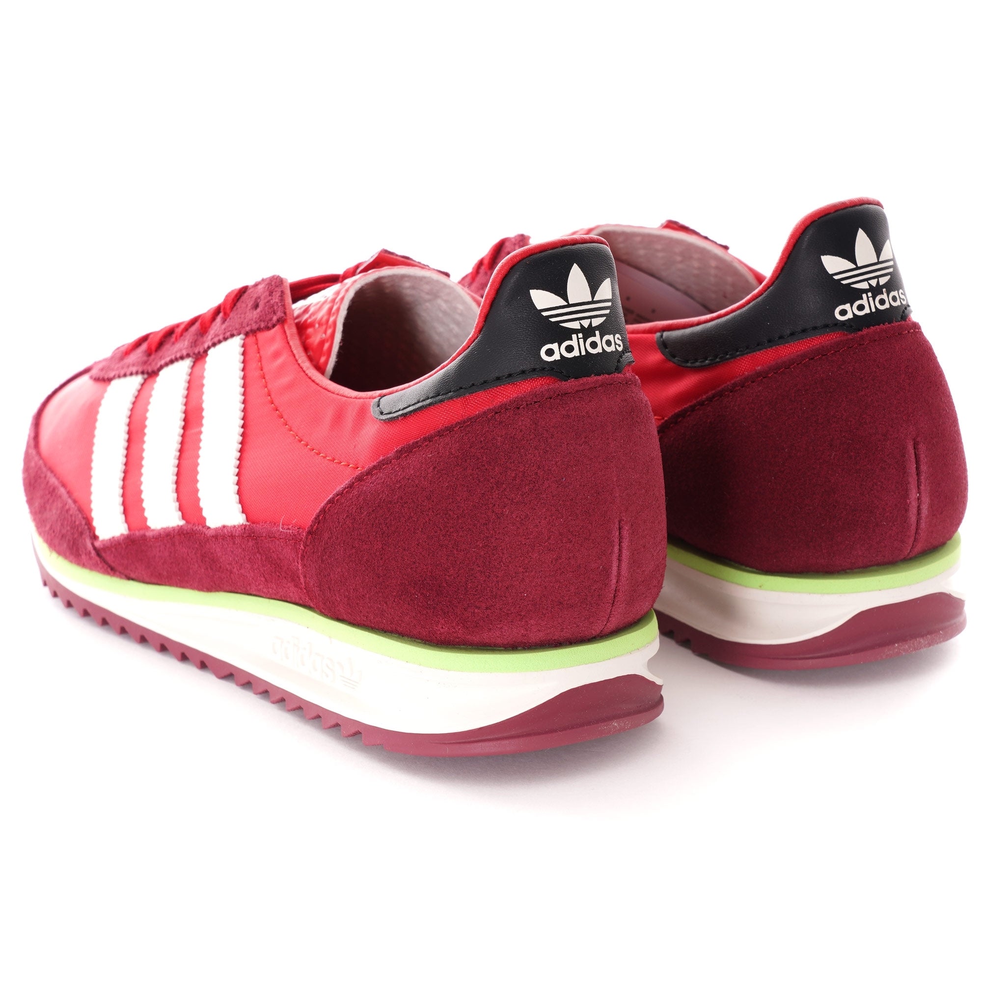 A rear-facing, slightly elevated shot of a pair of red adidas SL 72 RS trainers.