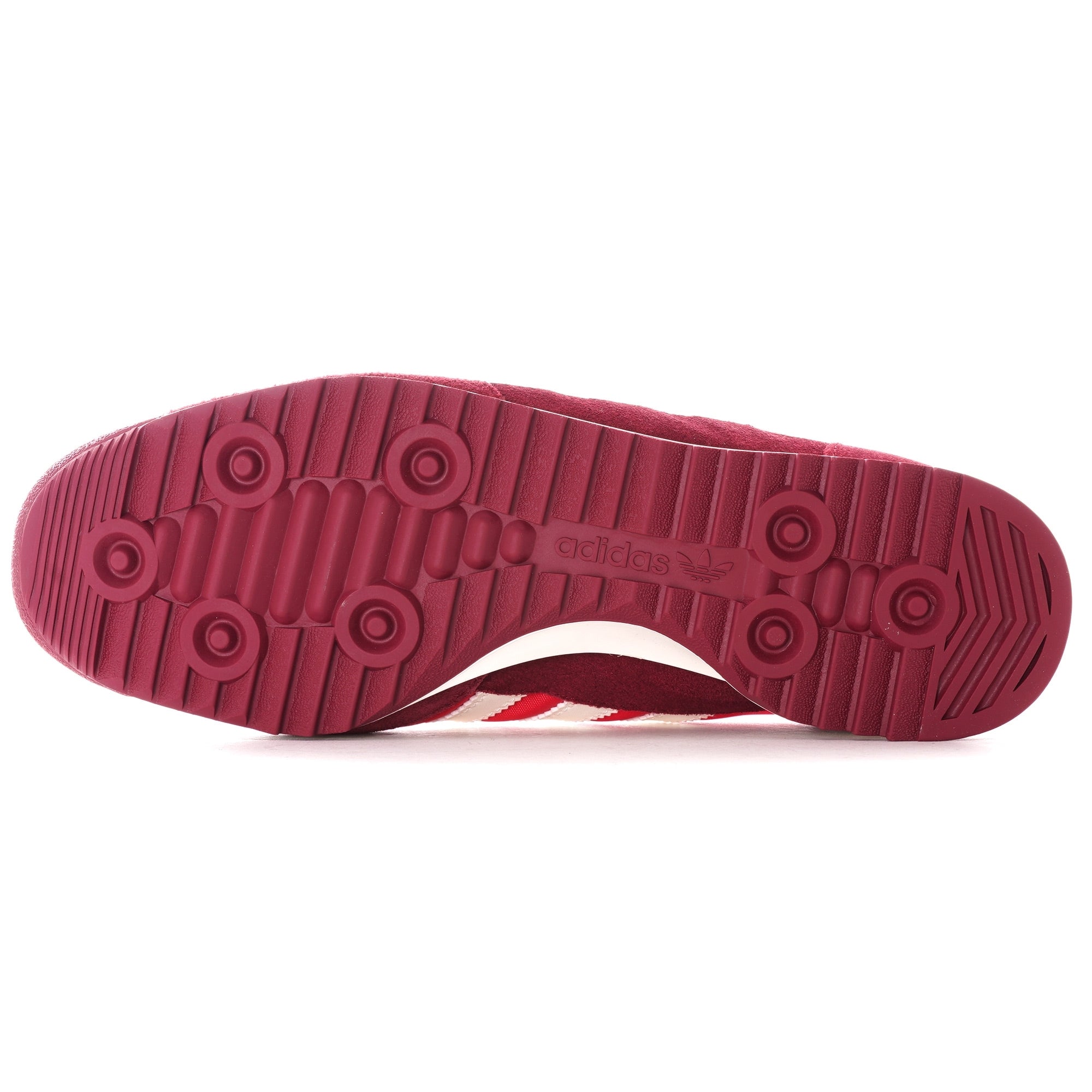 The sole of a red adidas SL 72 RS trainer, showing the circular tread pattern.