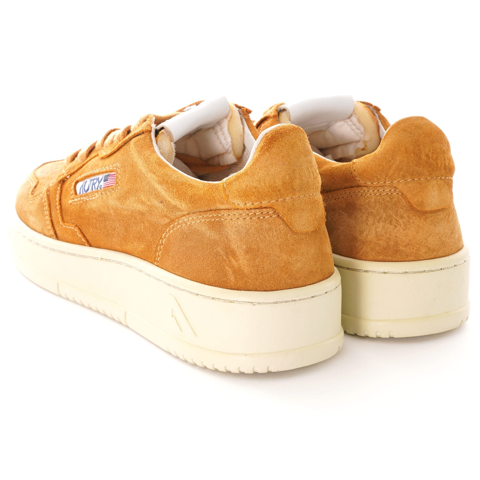 Rear view of two Autry Medalist Low Suede in tan, showcasing the cream soles.