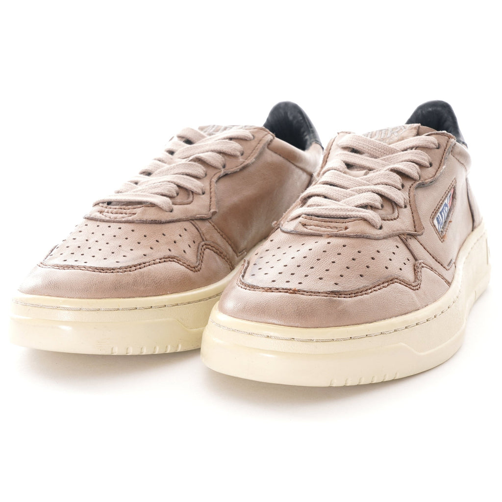 Pair of Autry Medalist Low sneakers in grey-brown leather from a slightly elevated front view.