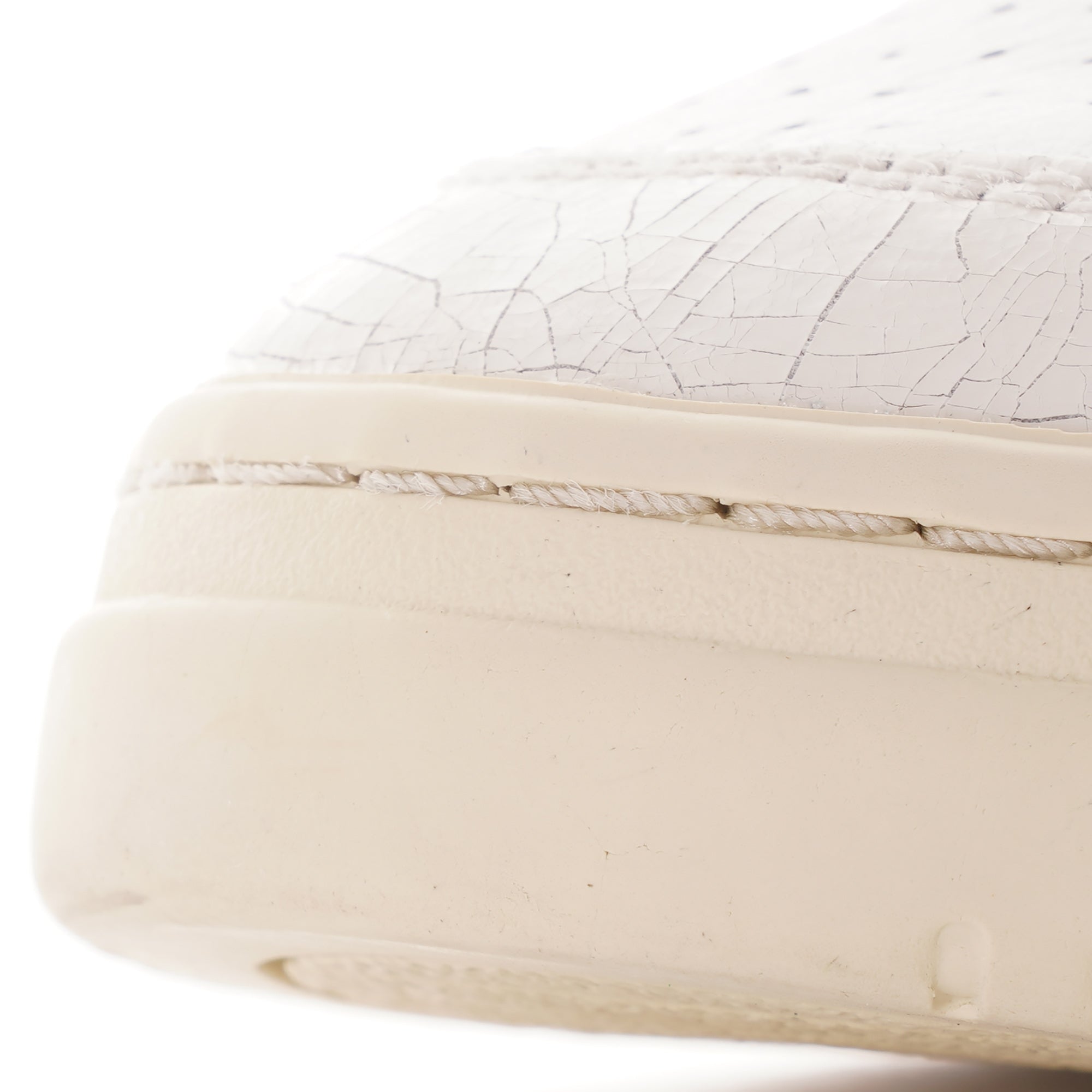 Close-up of the cracked leather detail on the toe of an Autry Medalist trainer.