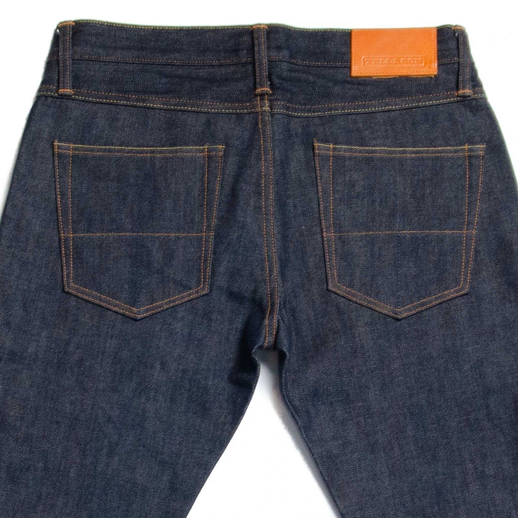 Rear view of the jeans, detailing the back pockets and leather patch.
