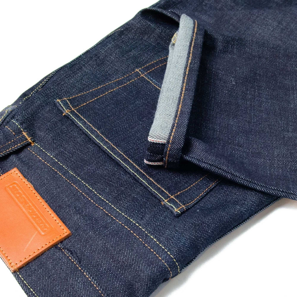 Close-up of the jeans' cuff and selvedge detail, with the leather patch visible.