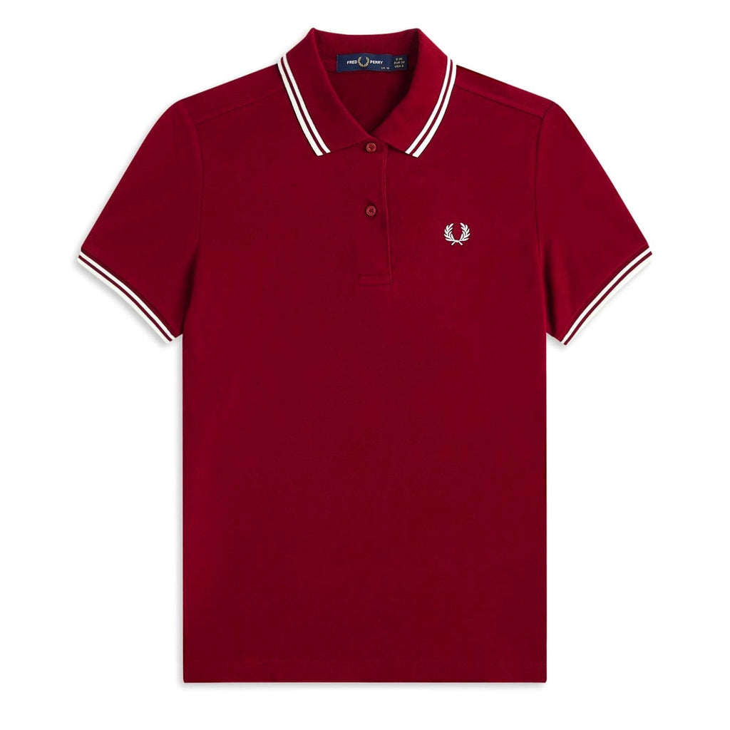 A close-up of a Fred Perry polo shirt in a rich, dark red with white twin-tipping.