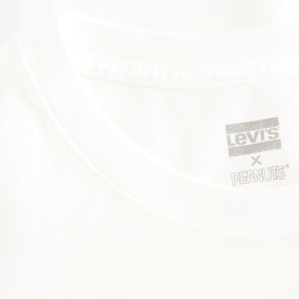 A close-up of the Levi's x Peanuts tag on a white t-shirt.