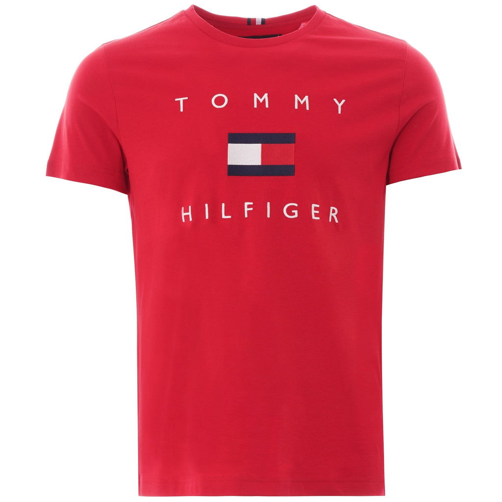 A close-up of a red Tommy Hilfiger T-shirt featuring the brand's logo.